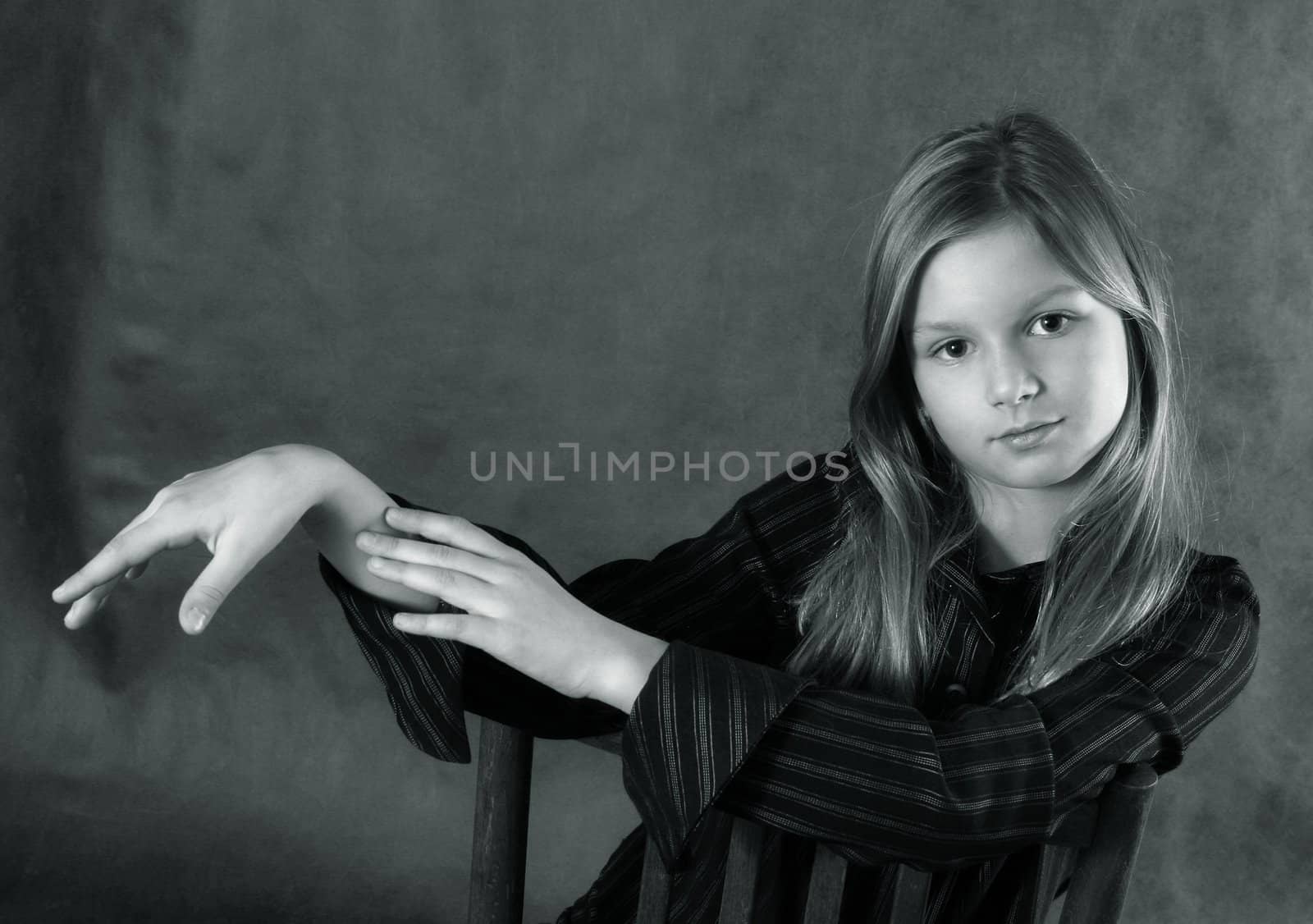 Portrait of the young girl with hands in studio. b/w+blue tone