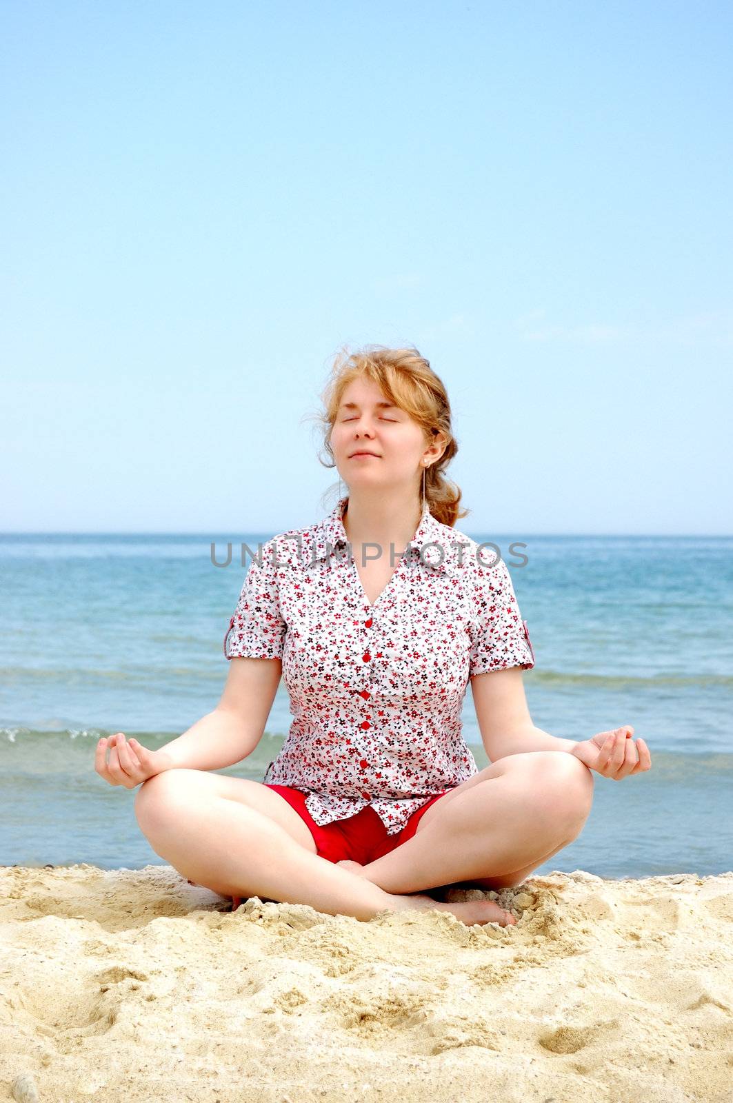 meditating women on the beach, sea, sky