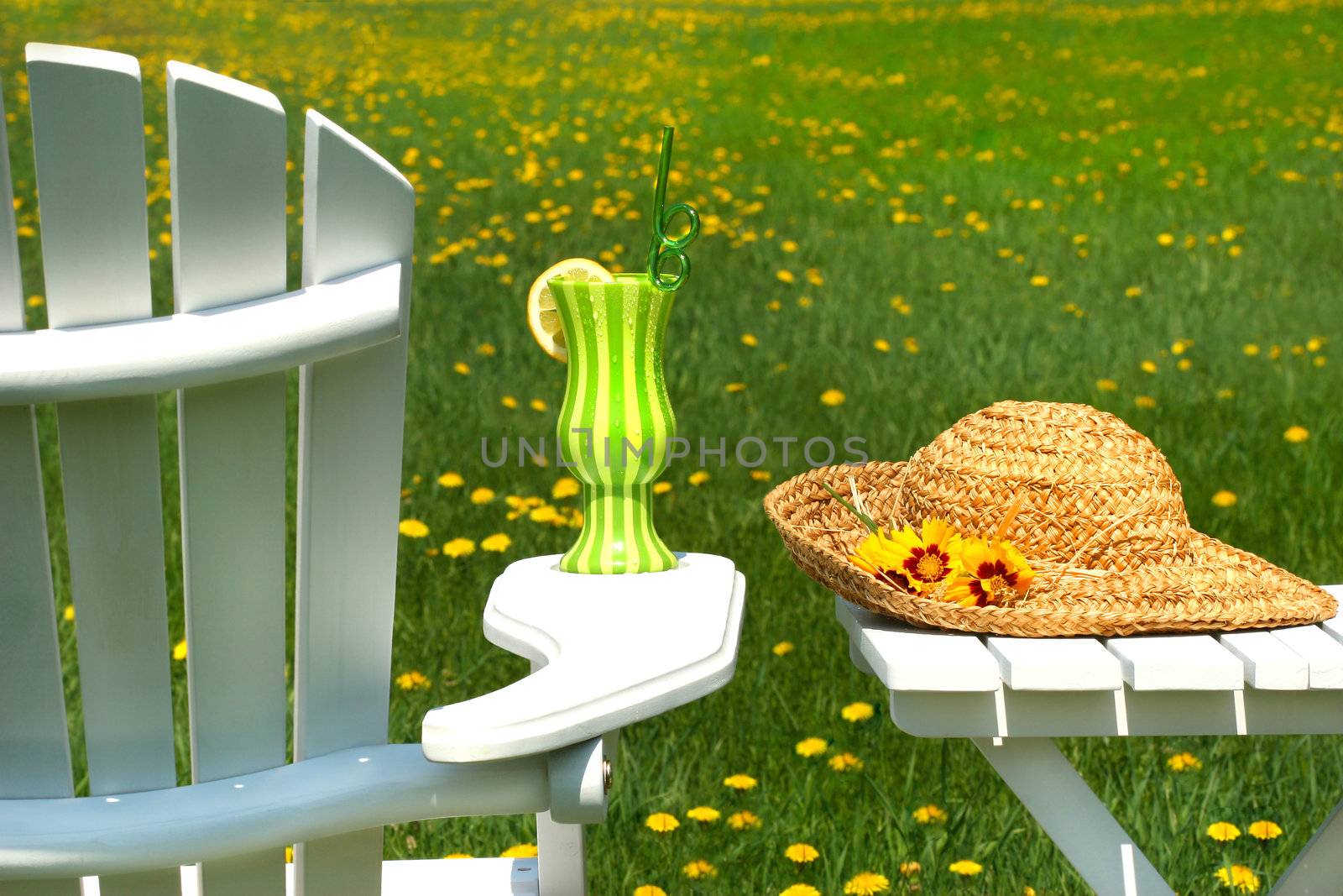 Adirondack chair on the grass with cool summer drink