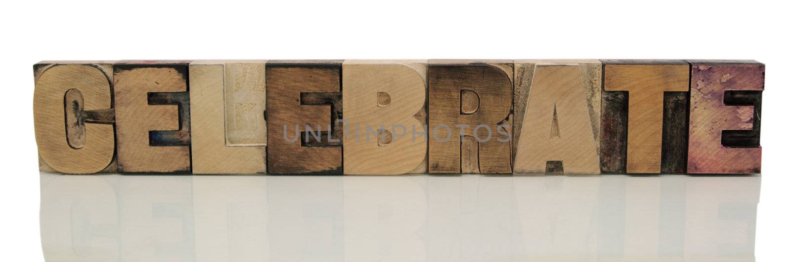 the word 'celebrate' in old wood type isolated on white with a reflection