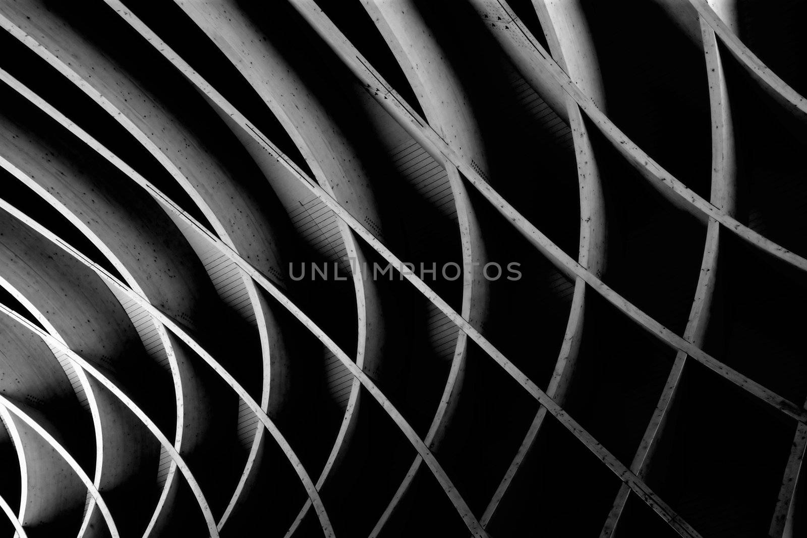 Dark black and white image of an abstract wooden architectural element.
