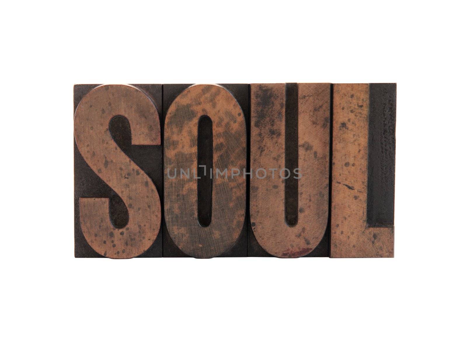 the word 'soul' in old, ink-stained wood letters isolated on white