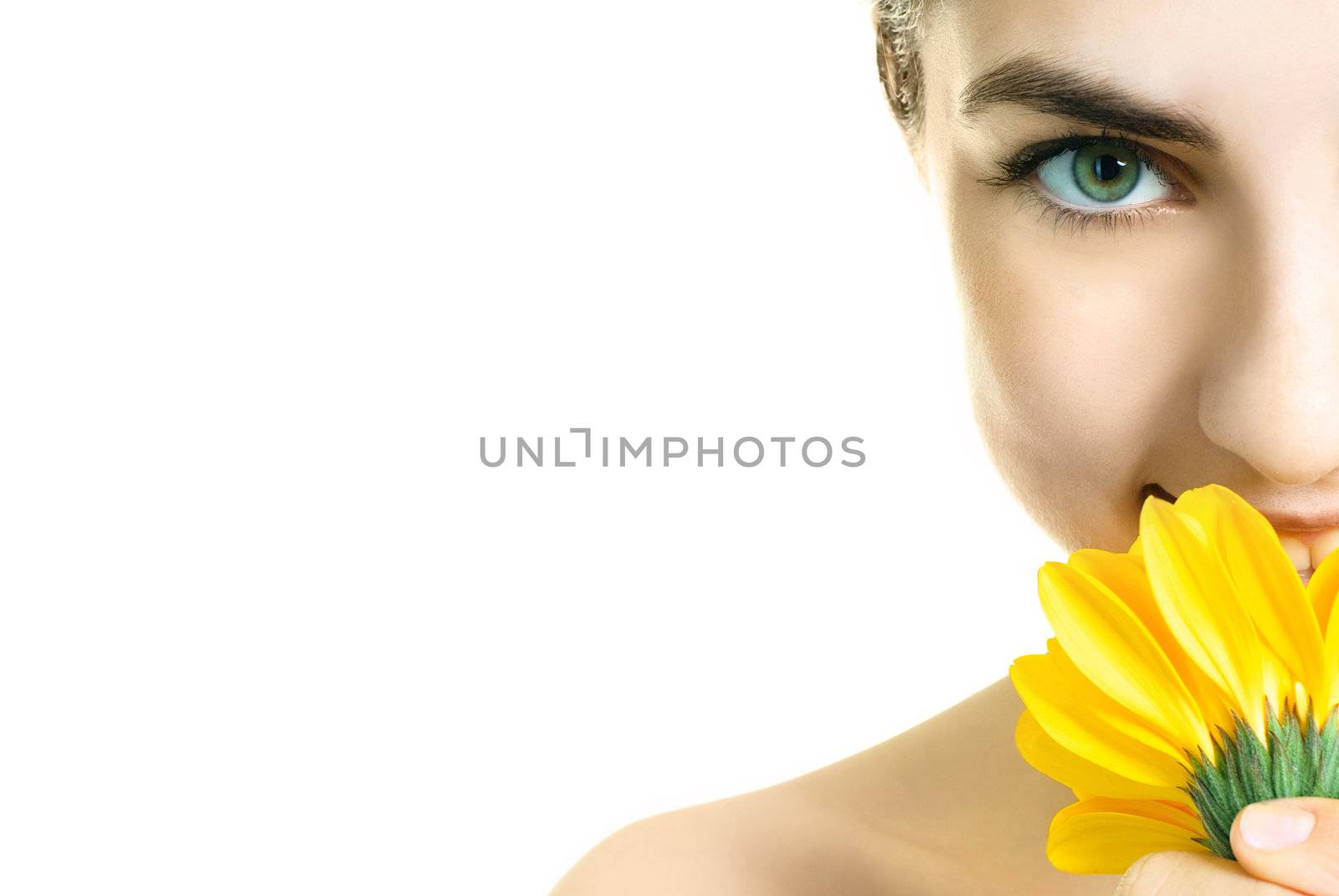 closeup of a pretty young woman with a yellow flower
