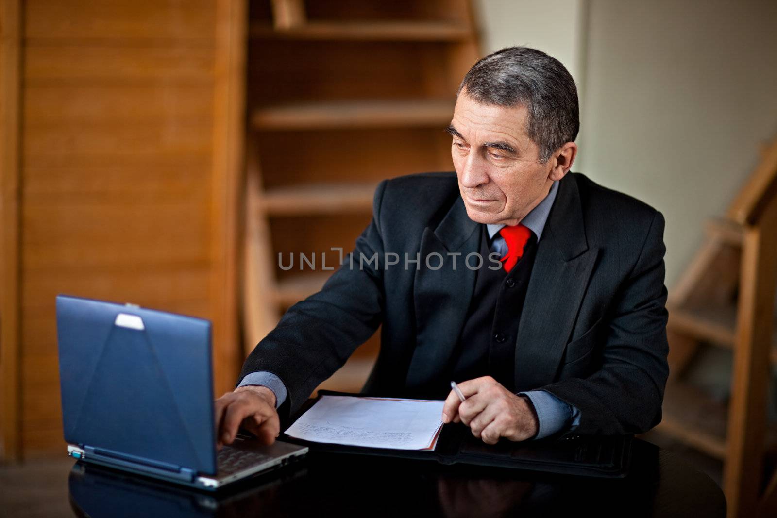 Business man typing and working on laptop computer
