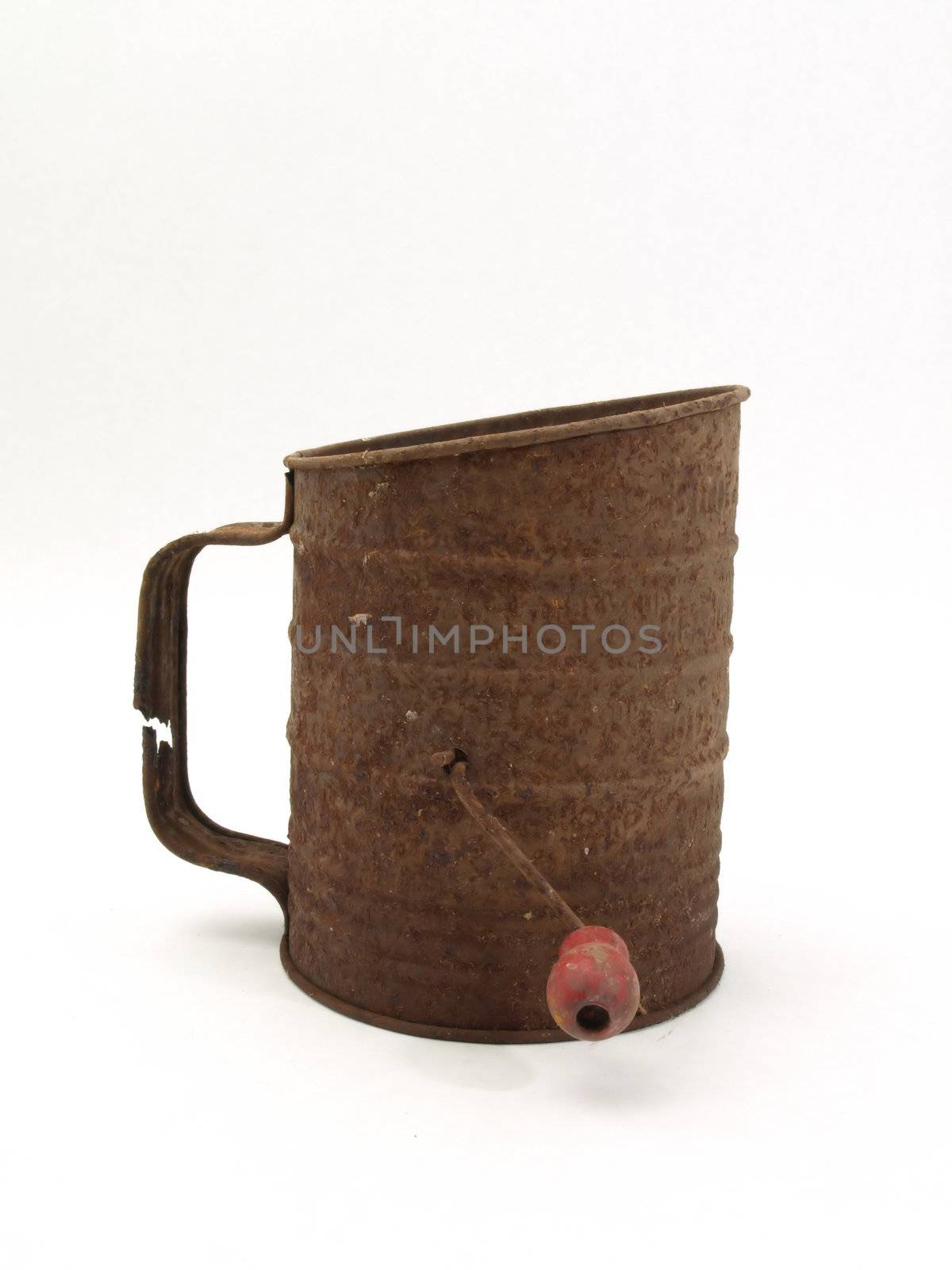 An old rusty flour sifter isolated on a white background.