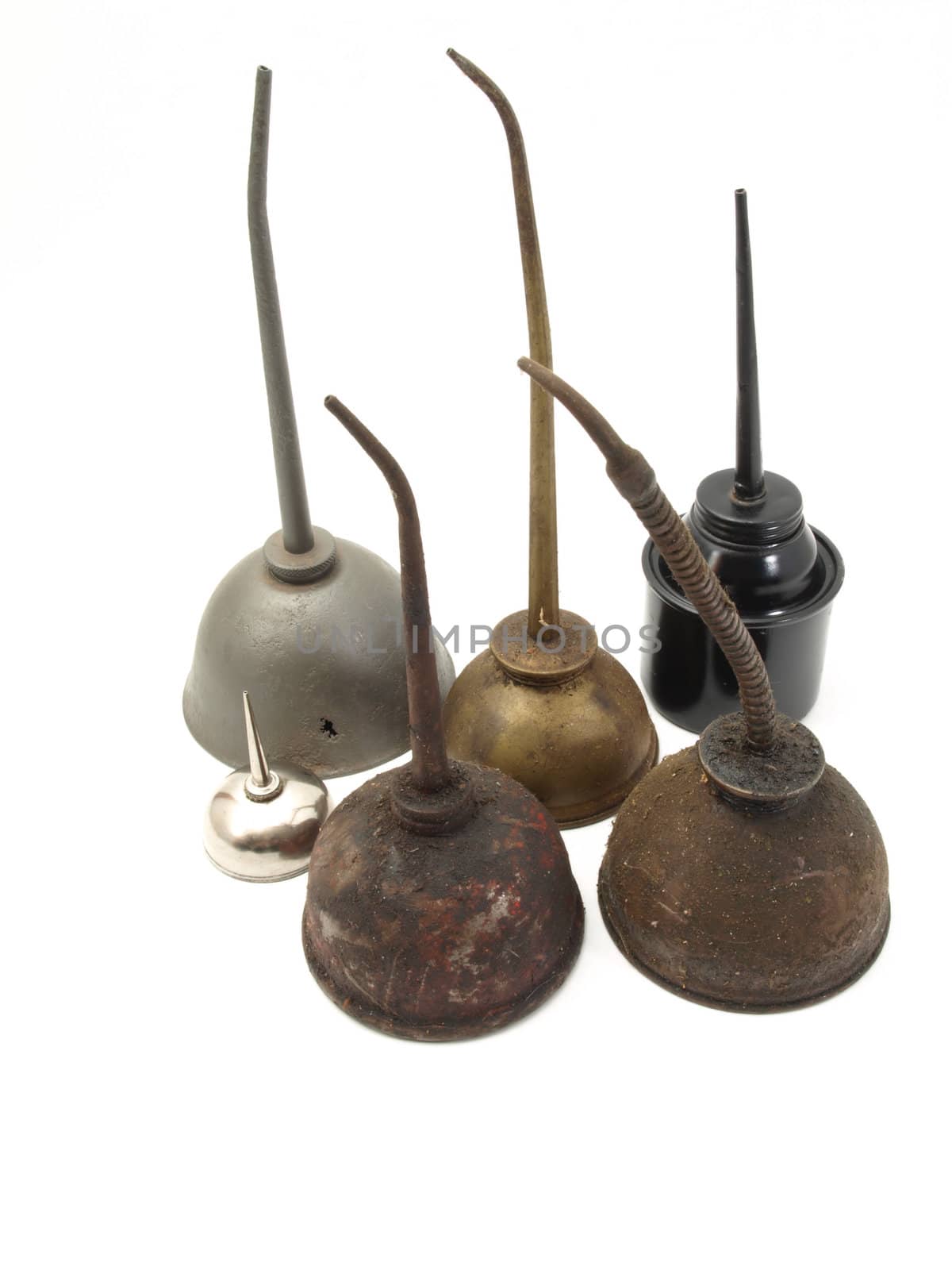 A group of oil cans, obsolete and modern, studio isolated over a white background.