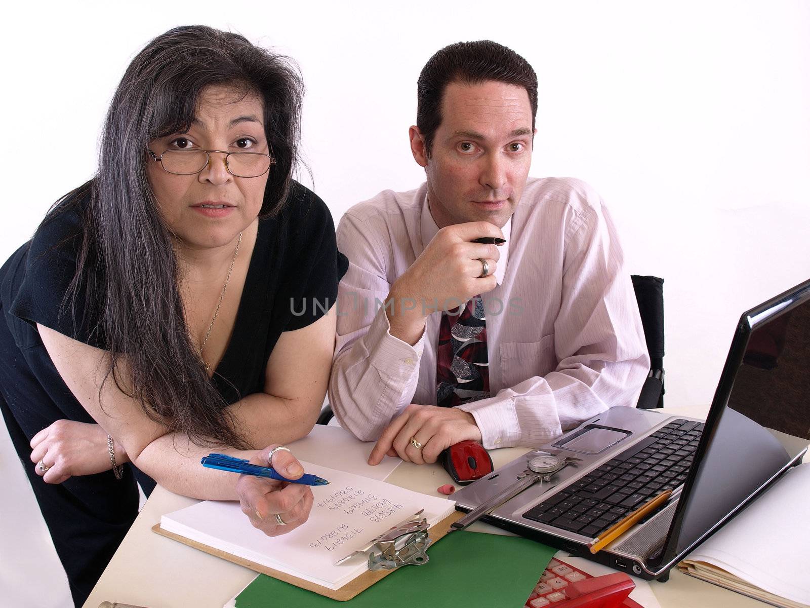 A male and female working together in the office at the computer. Isolated against a white background.