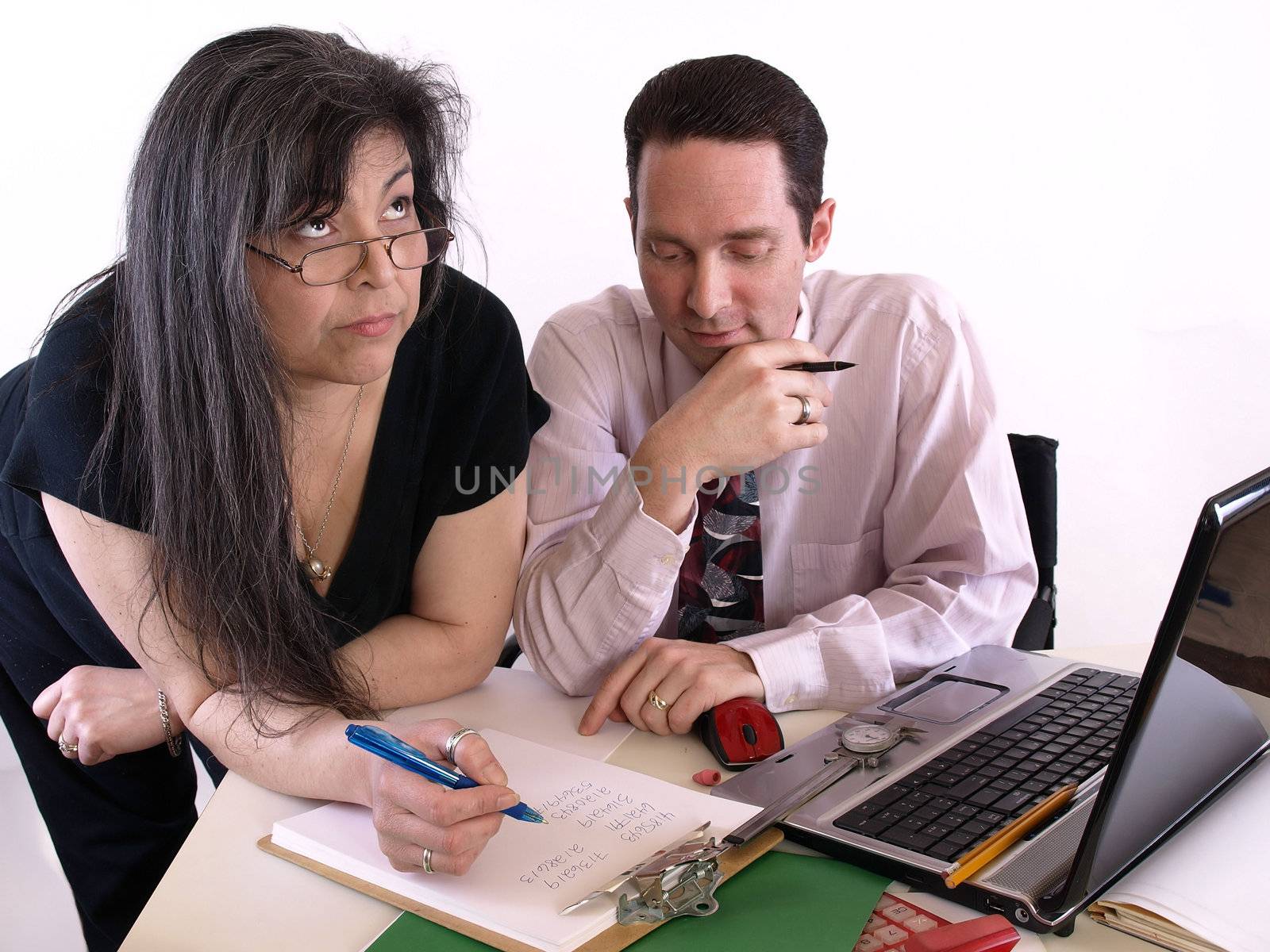 A male and female working together in the office at the computer. Isolated against a white background.