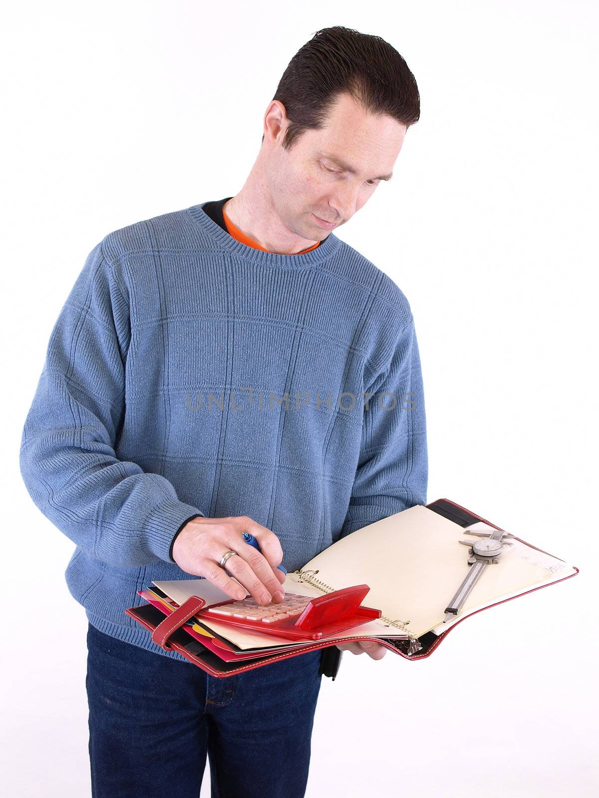 An adult male in blue checks over some measurements in a binder. Isolated on a white background.