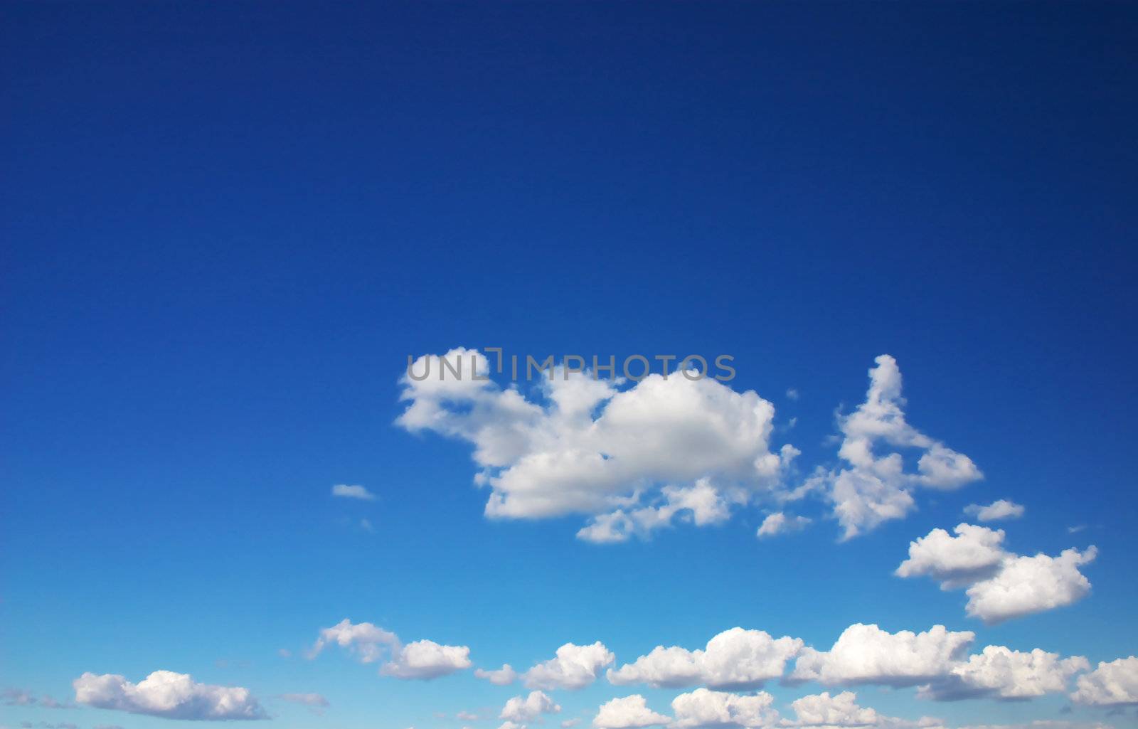 blue sky with white fluffy clouds, plenty of copy space