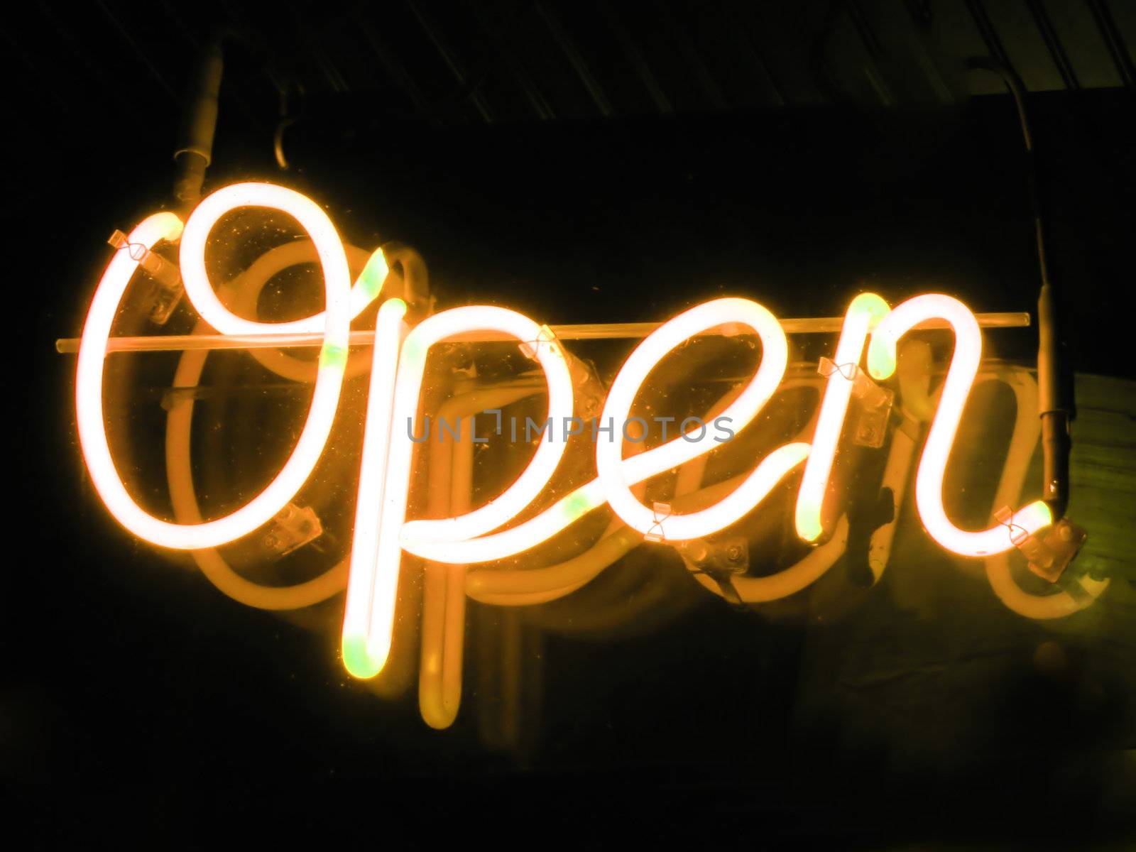 A neon orange OPEN sign glowing in the window of a restaurant.
