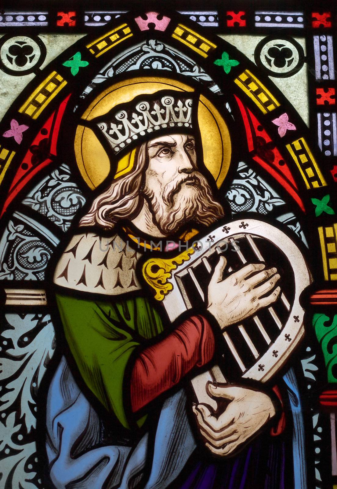 detail of victorian stained glass church window in Fringford depicting King David, the author fo the psalms in the Old testament with a hand harp