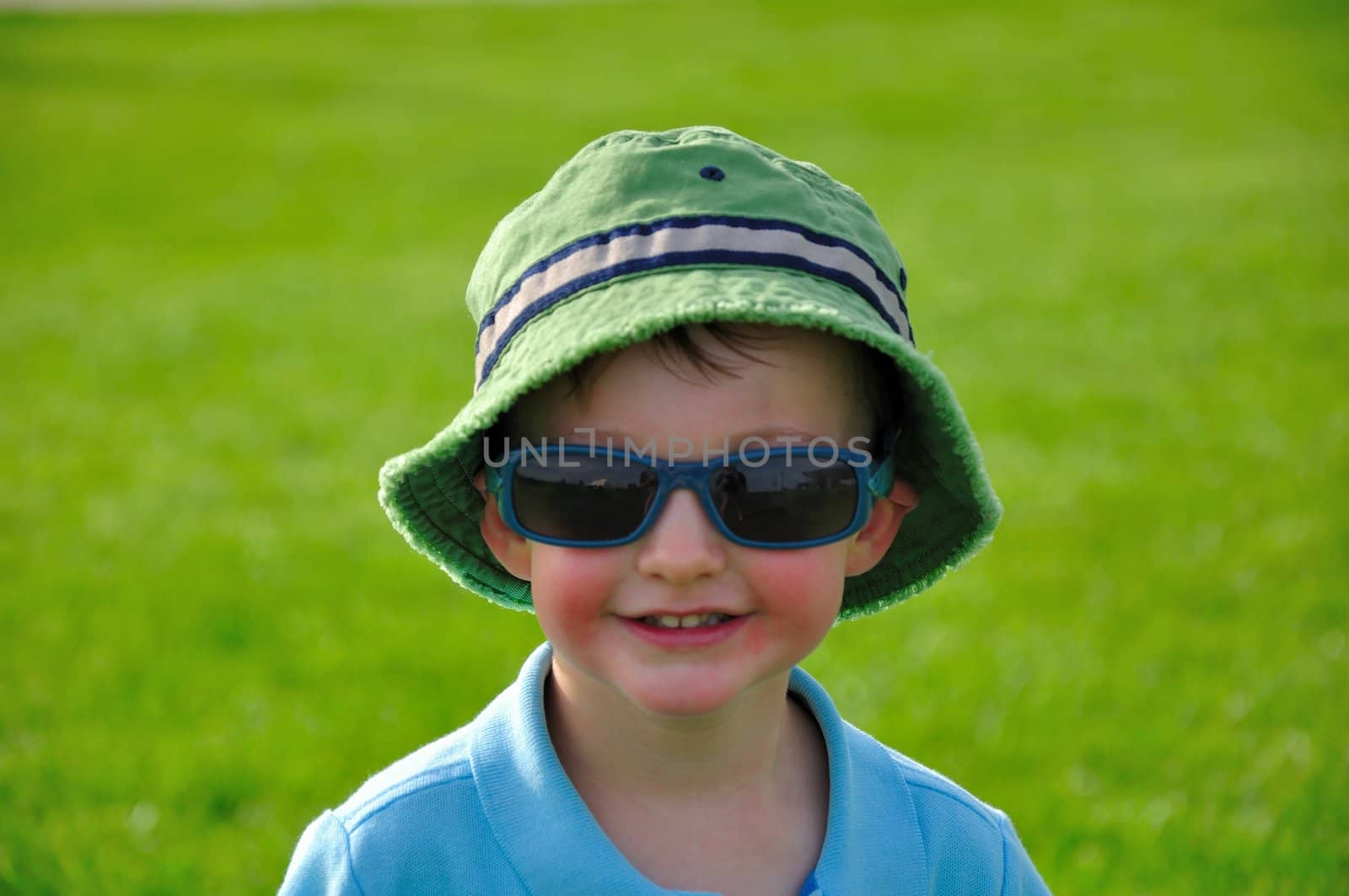 A cute little boy having fun out in the sun on a Summer day.