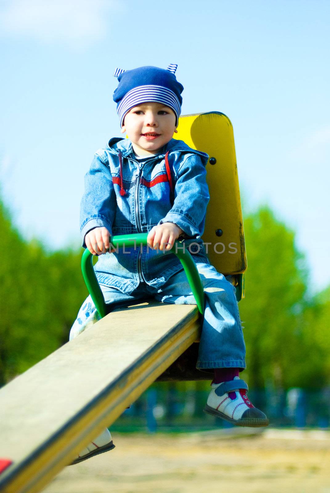 cute three year old boy having fun in the park outdoor