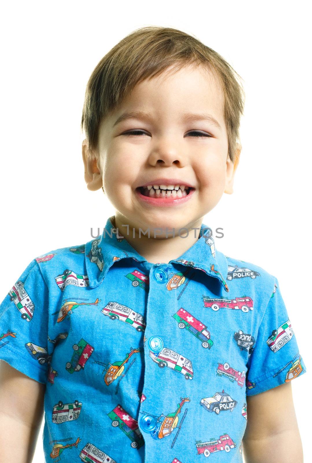 portrait of a cute three year old boy looking at us with a smile
