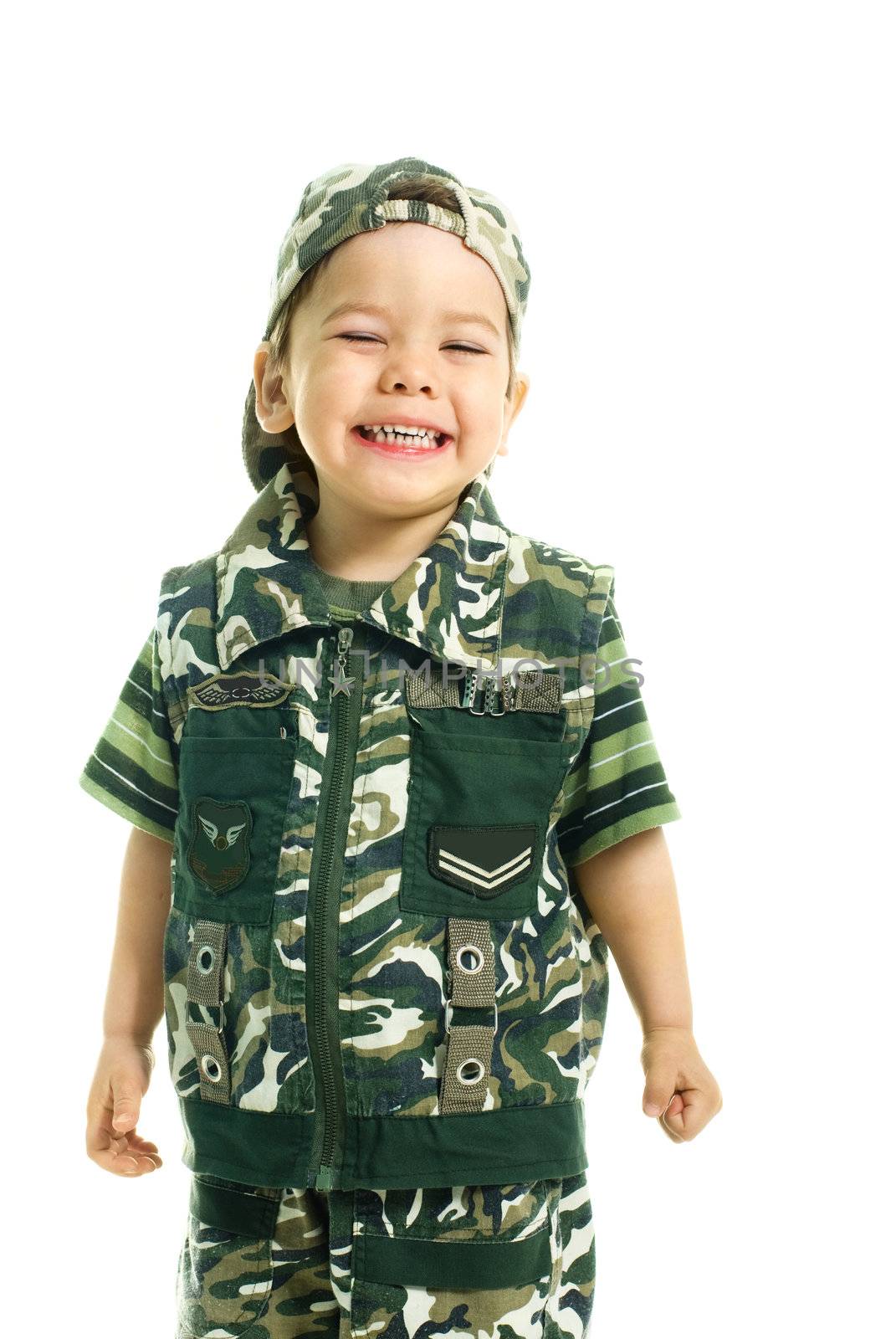 portrait of a cute excited three year old boy dressed in camouflage