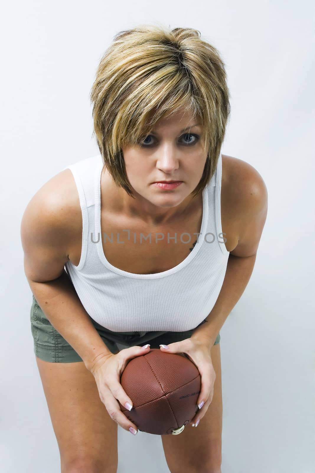 Beautiful model takes on an intense look and ready to run a football play.