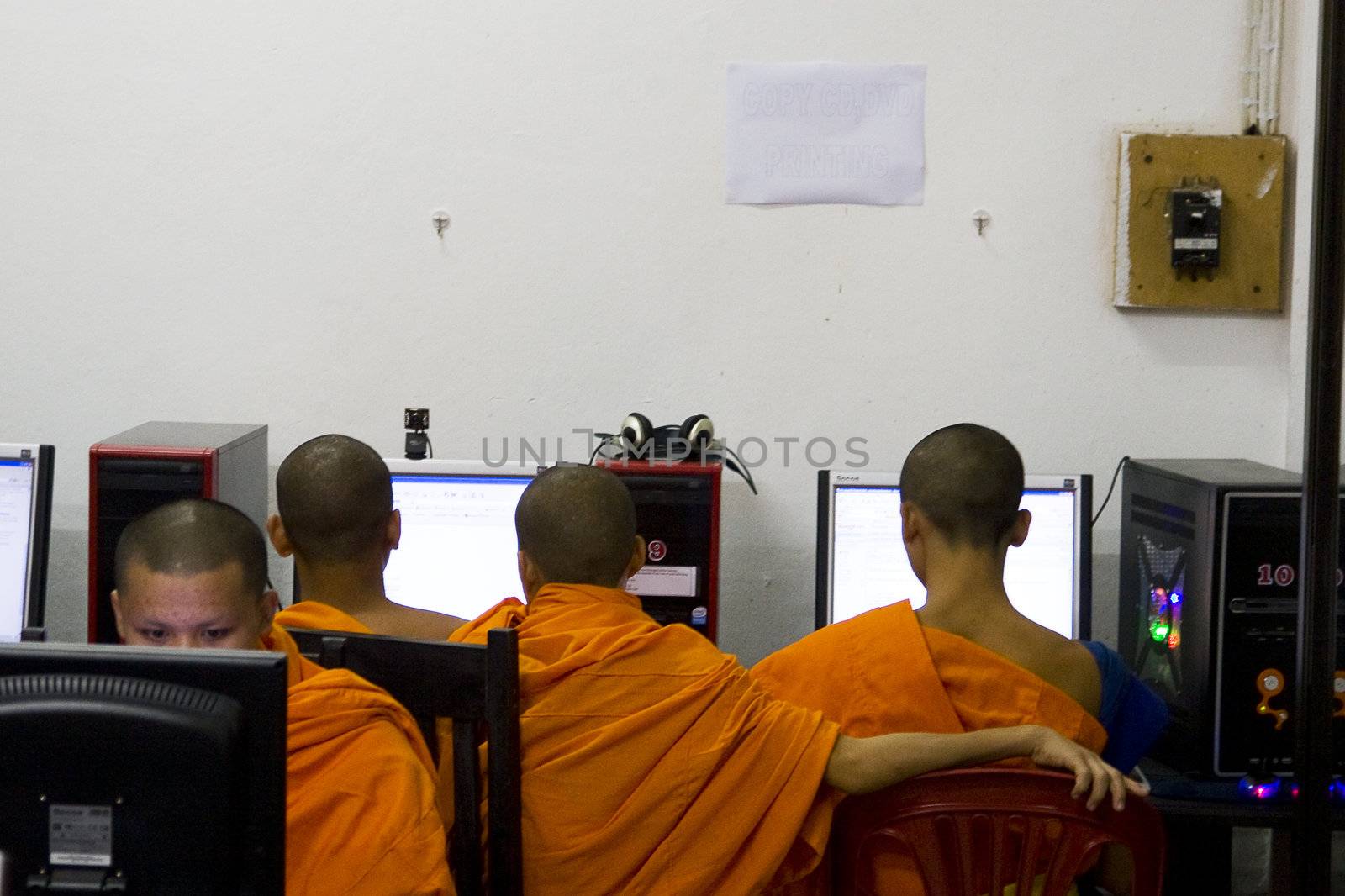 Young Monks in Luang Prabang spend their free time on the Internet. Illustrates how the new and old are getting more combined.