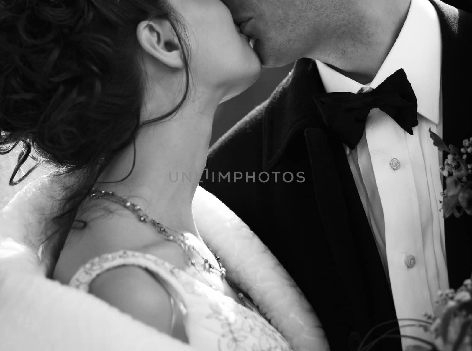 The groom and the bride kiss. b/w
