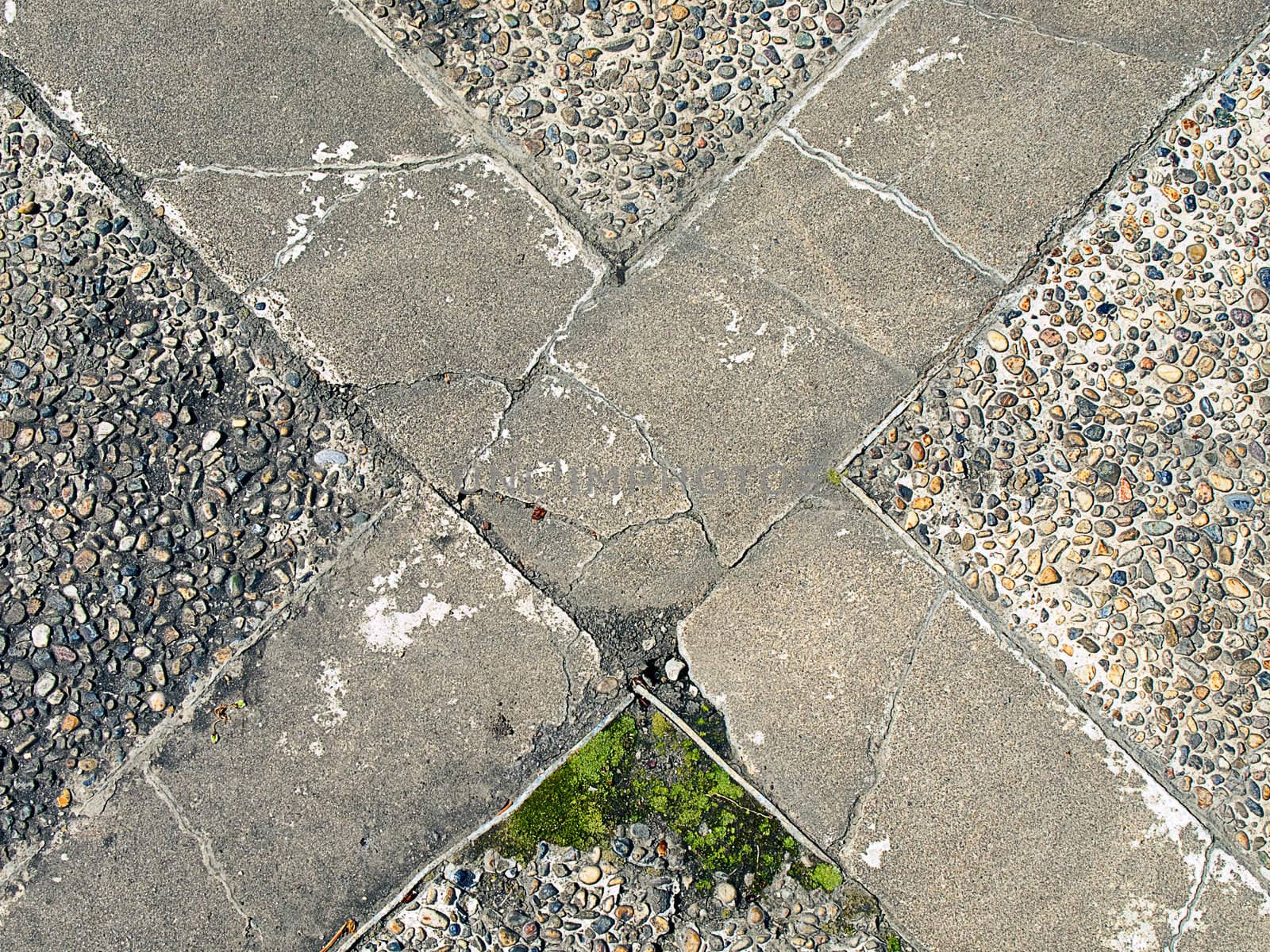 The letter X marks a spot on a concrete sidewalk.