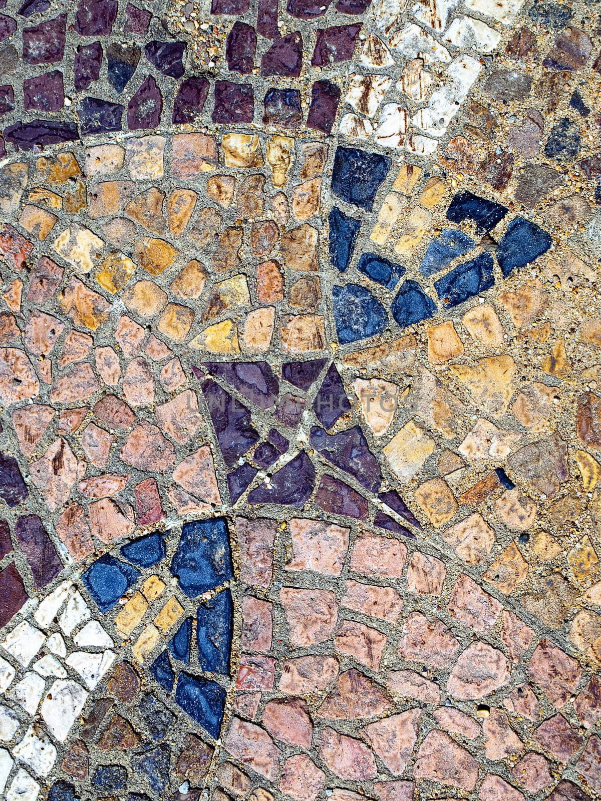 Abstract form, texture and color created with broken tile in cement.