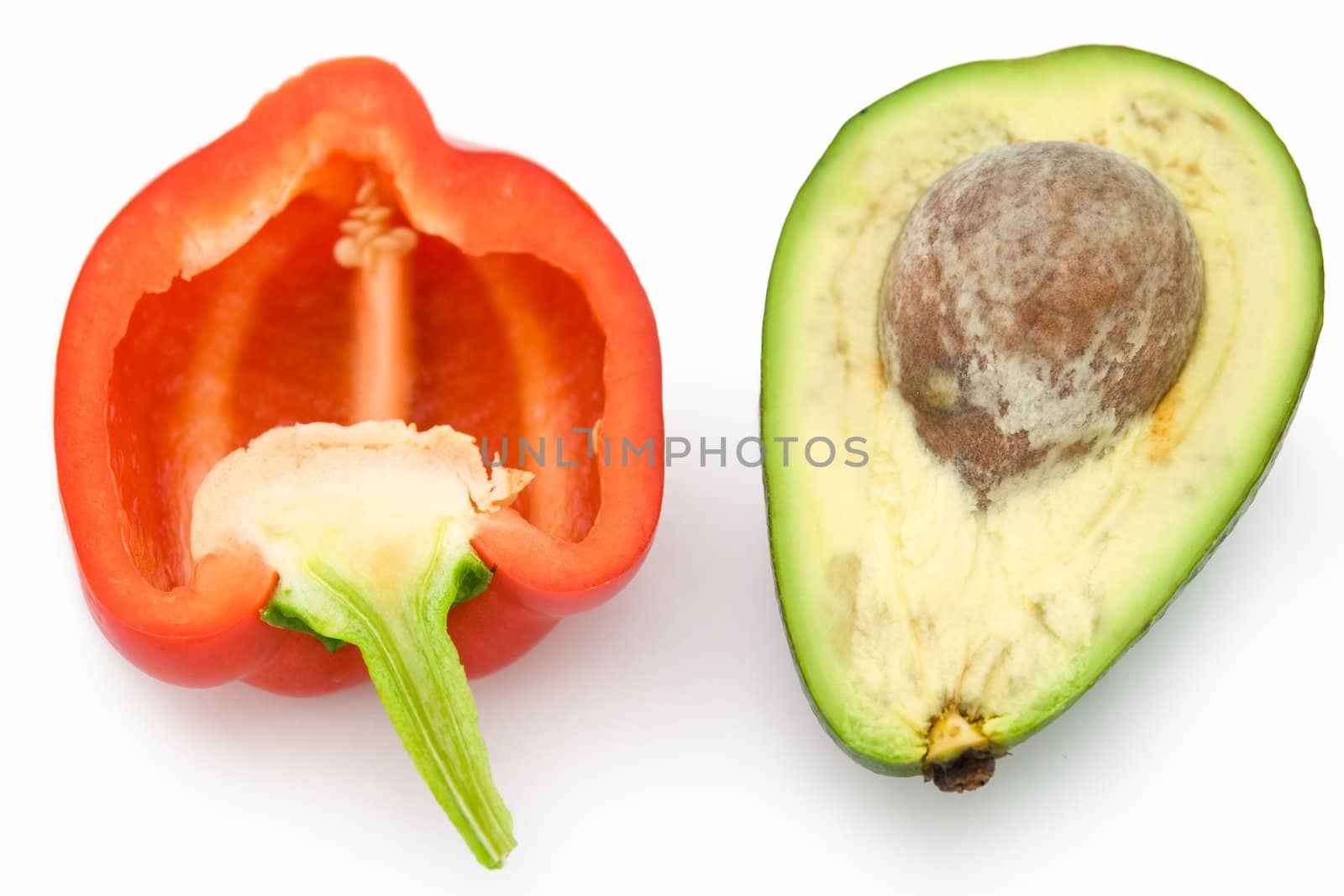 Red sweet pepper and green avocado on a white background