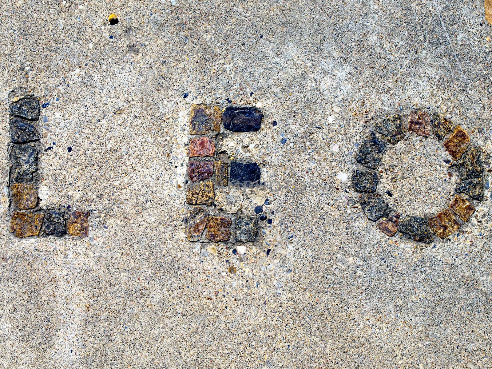 Astrological signs spelled out with inlayed tiles in cement.