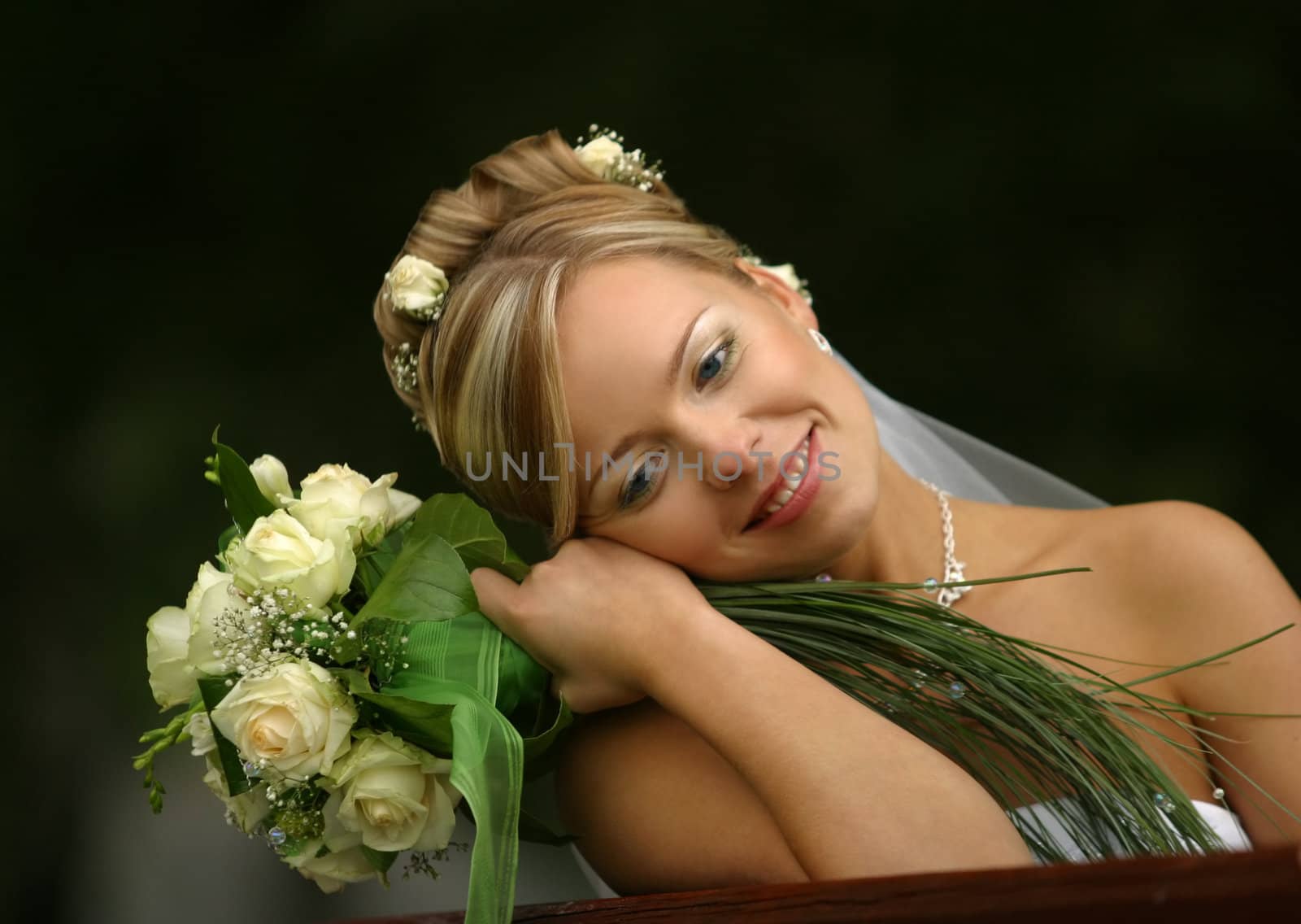 Portrait of the beautiful bride with a bouquet