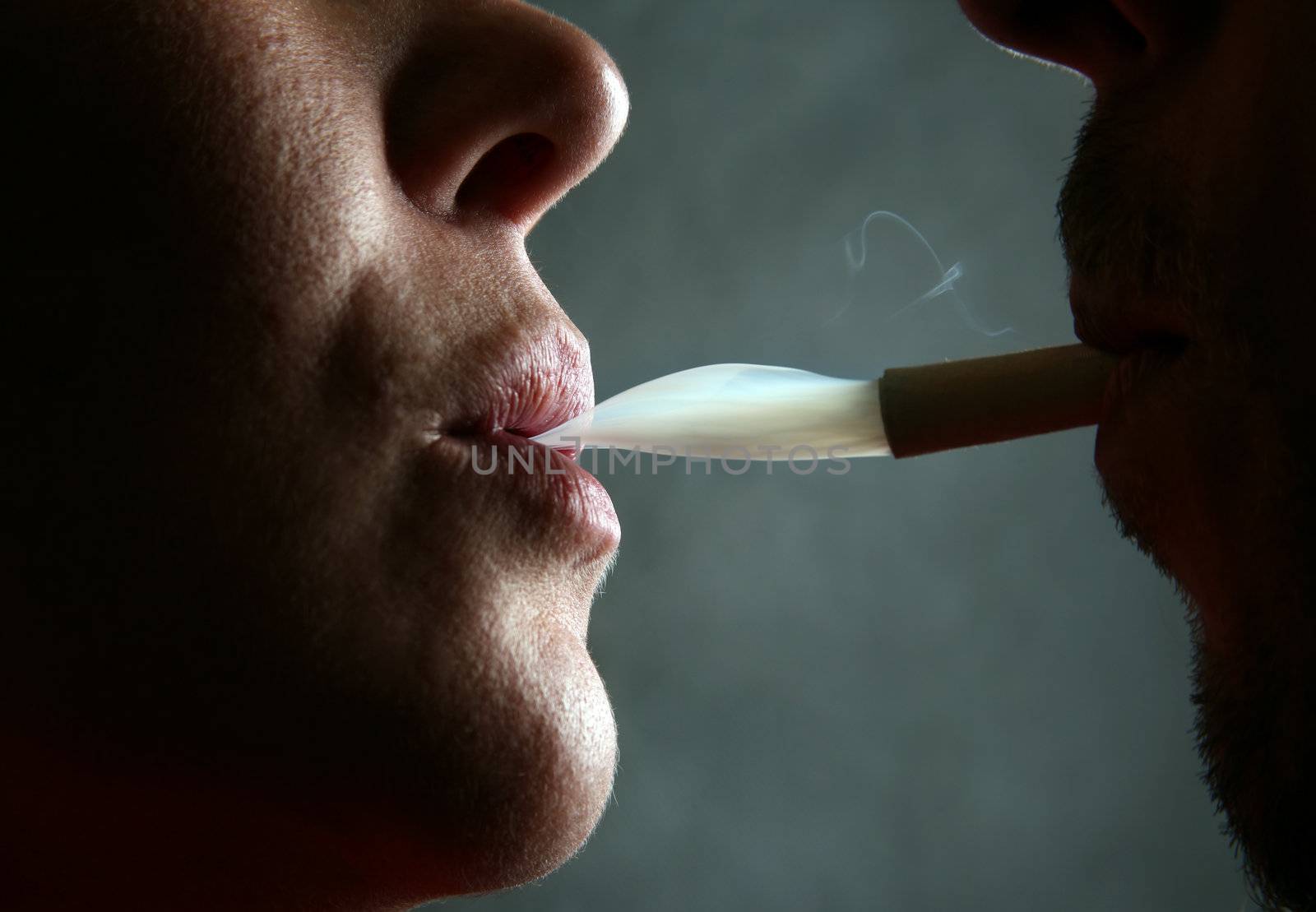 Two silhouettes of smoking people close-up