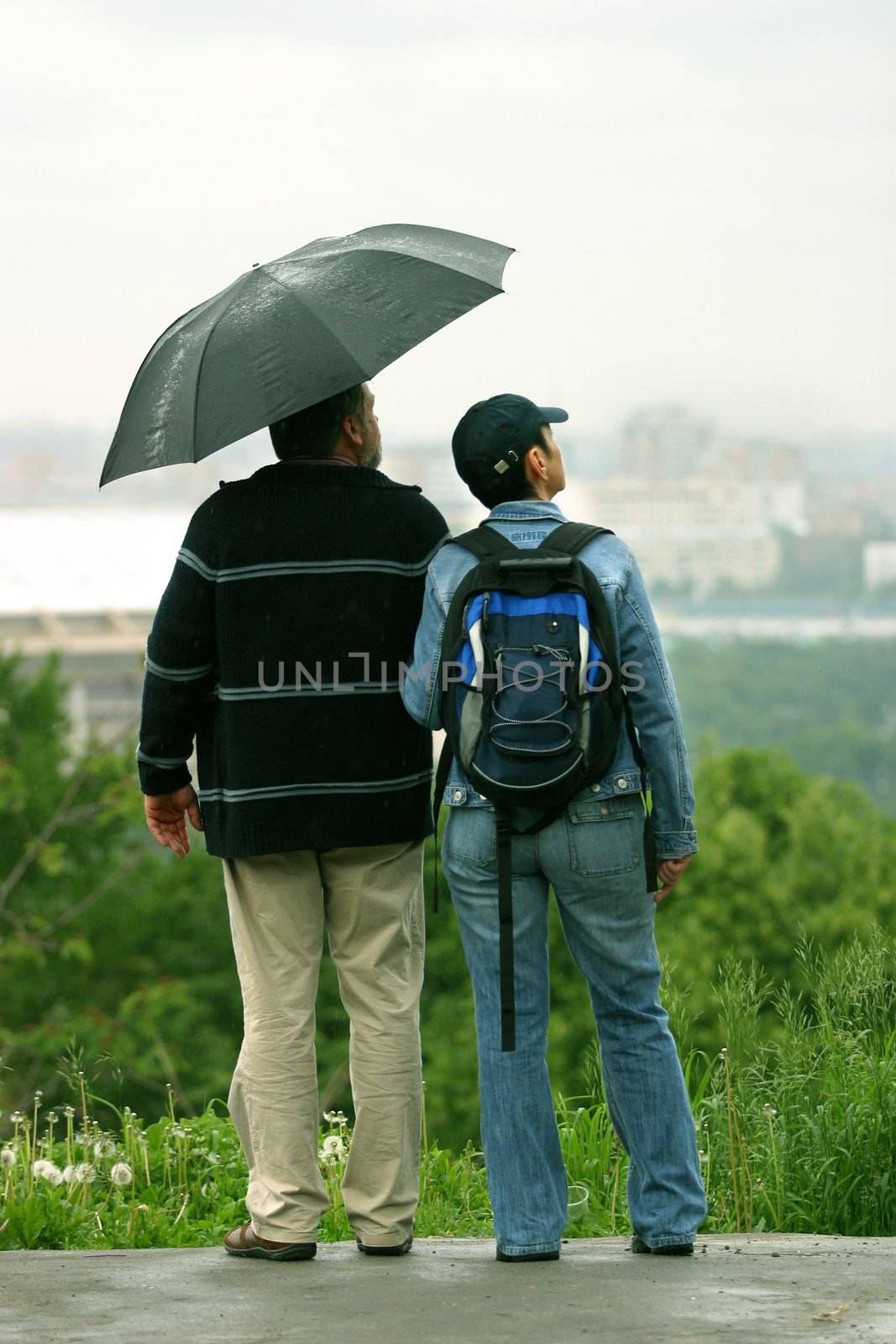 The man and the woman under a umbrella