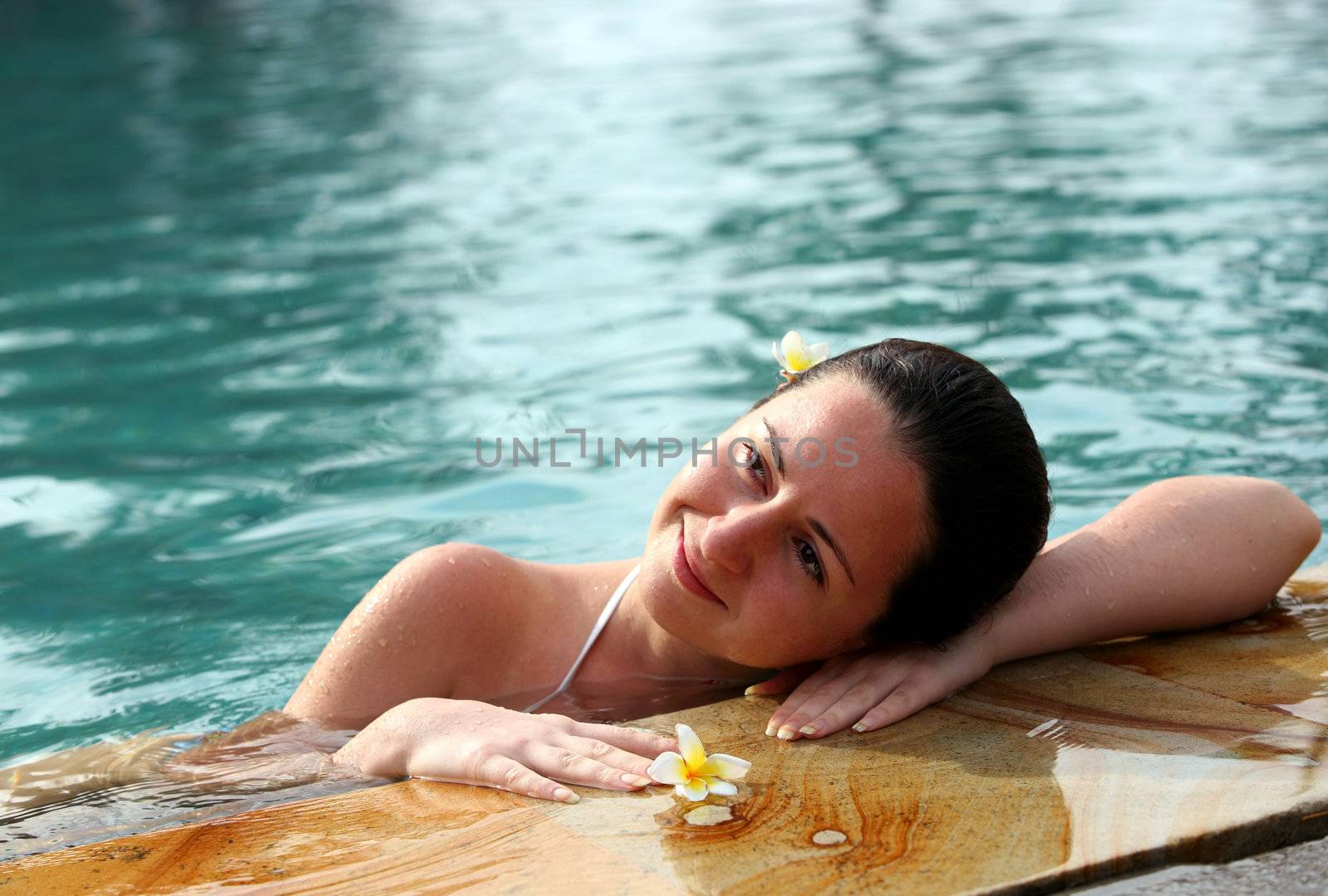 Beautiful woman enjoying summer in the pool