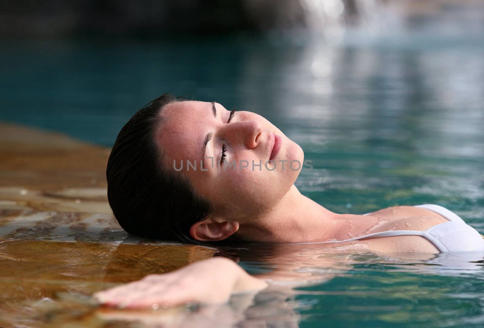 Beautiful woman enjoying summer in the pool