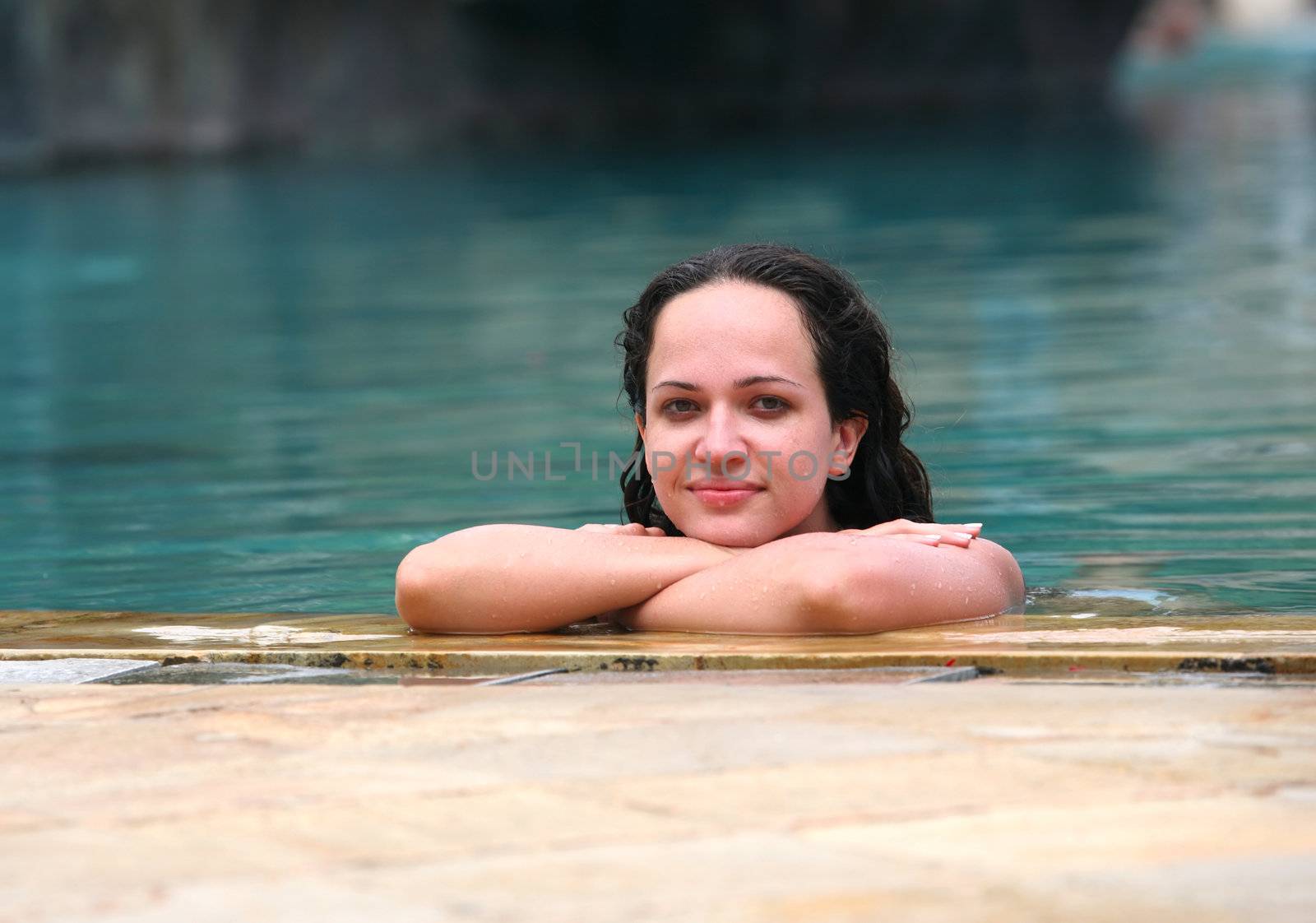 Beautiful woman enjoying summer in the pool