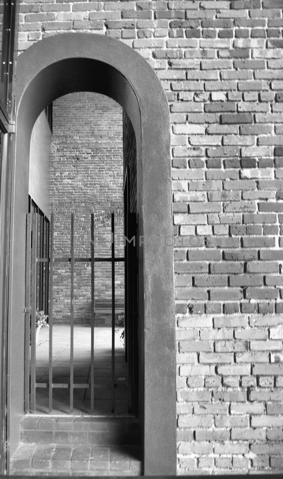narrow doorway with a gate shown in black and white