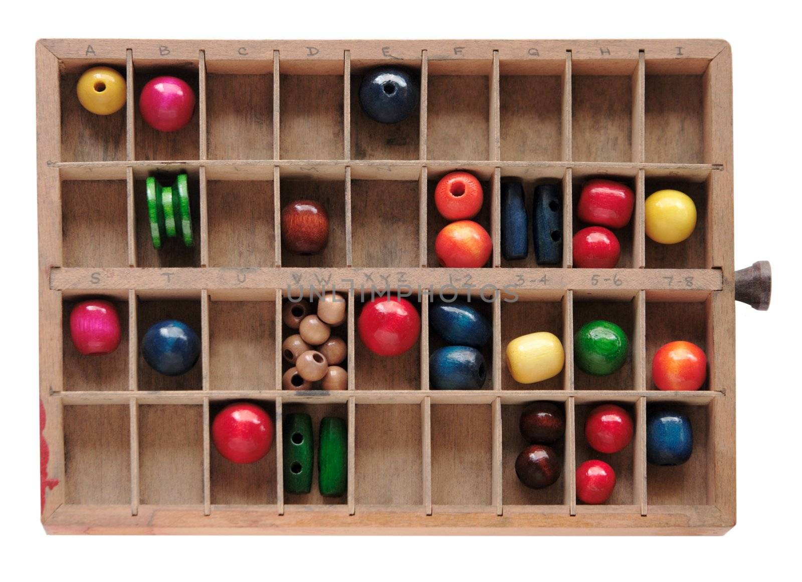 colorful, brightly painted beads in an old wood type box