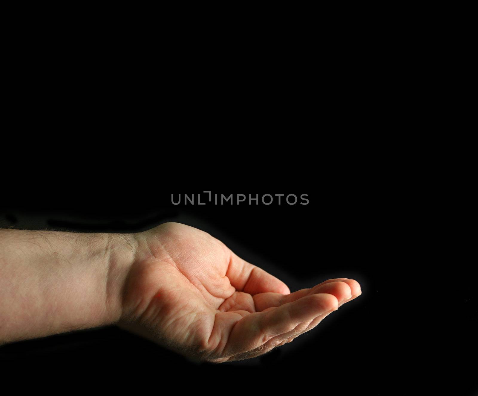 Cupped hand isolated on black.