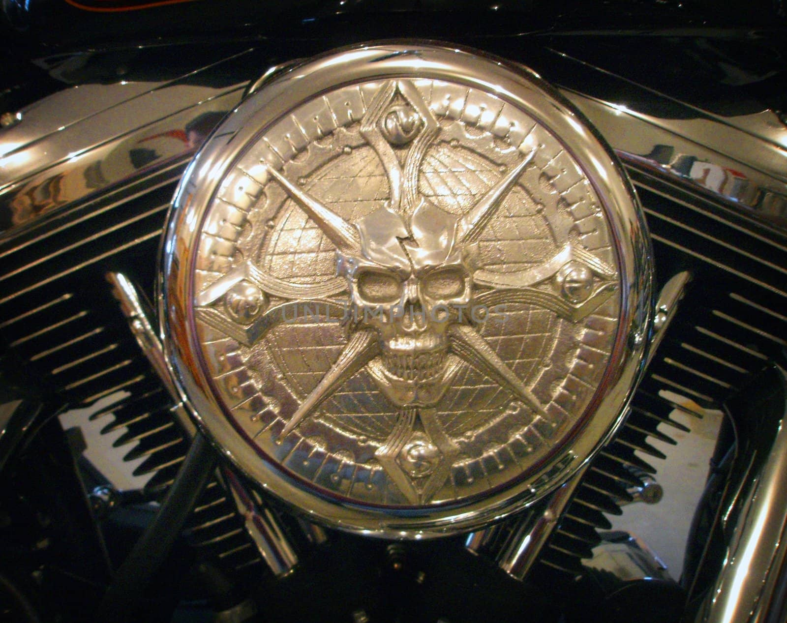 Close up image of an air filter cover on a Harley Davidson motorcycle with Skull.