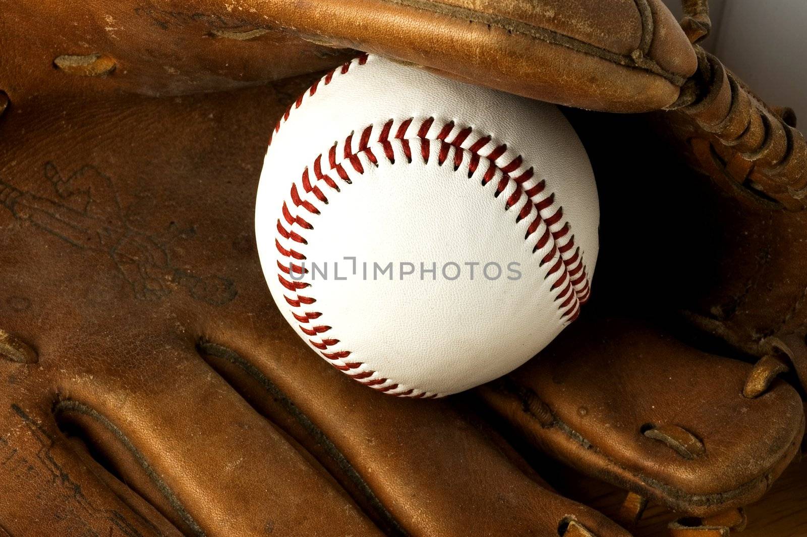 Baseball and old glove, detail.