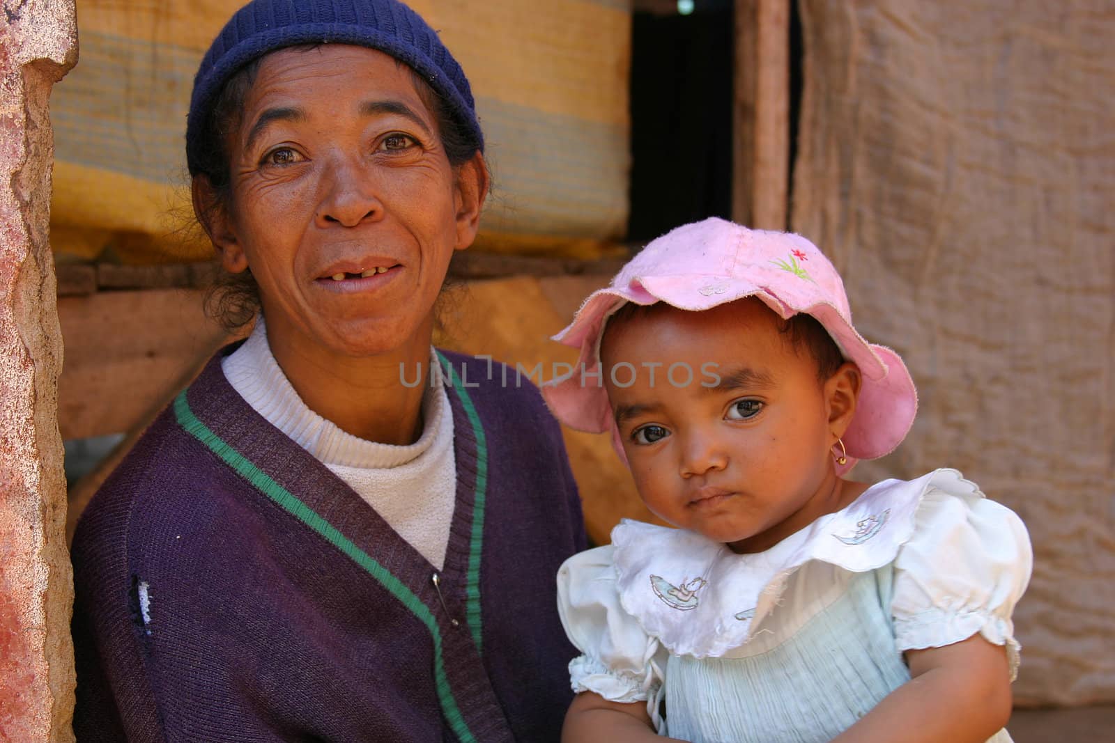 Elderly lady with a baby on her lap