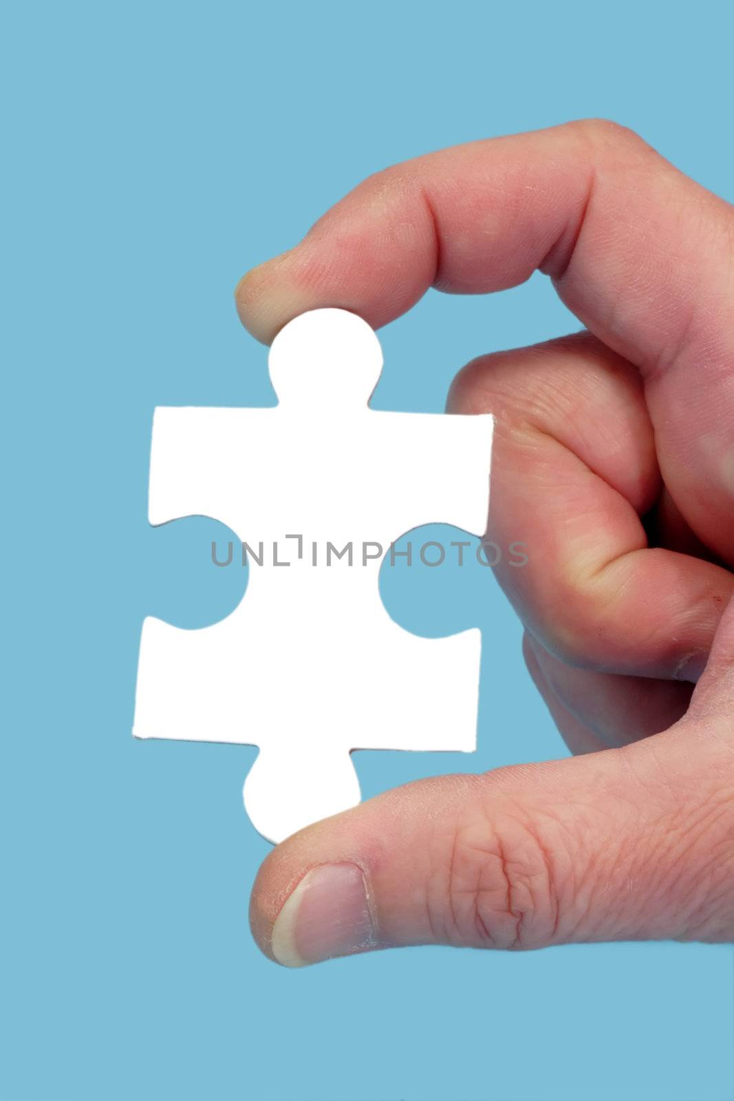 Hand and puzzle, isolated on blue background