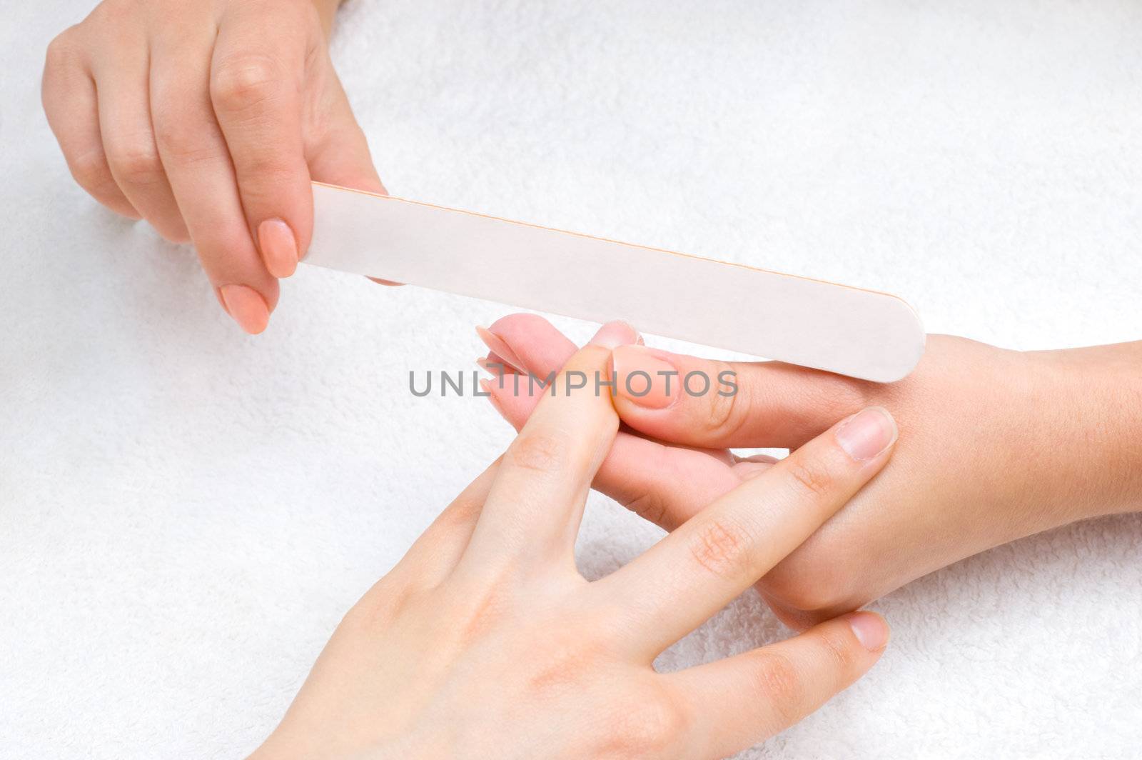 applying manicure with nail-file by starush