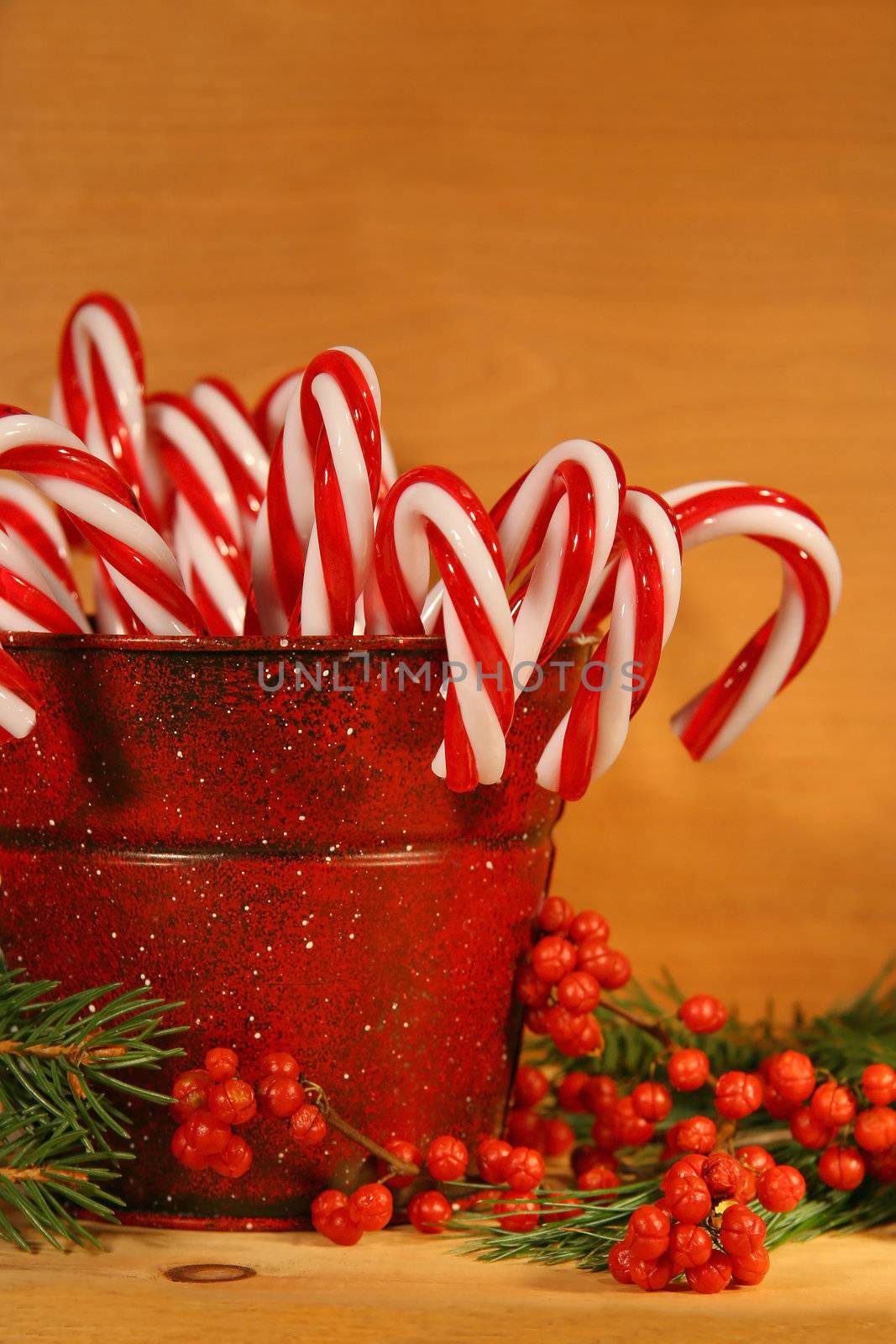 Candycanes and berries in  a red old tin can