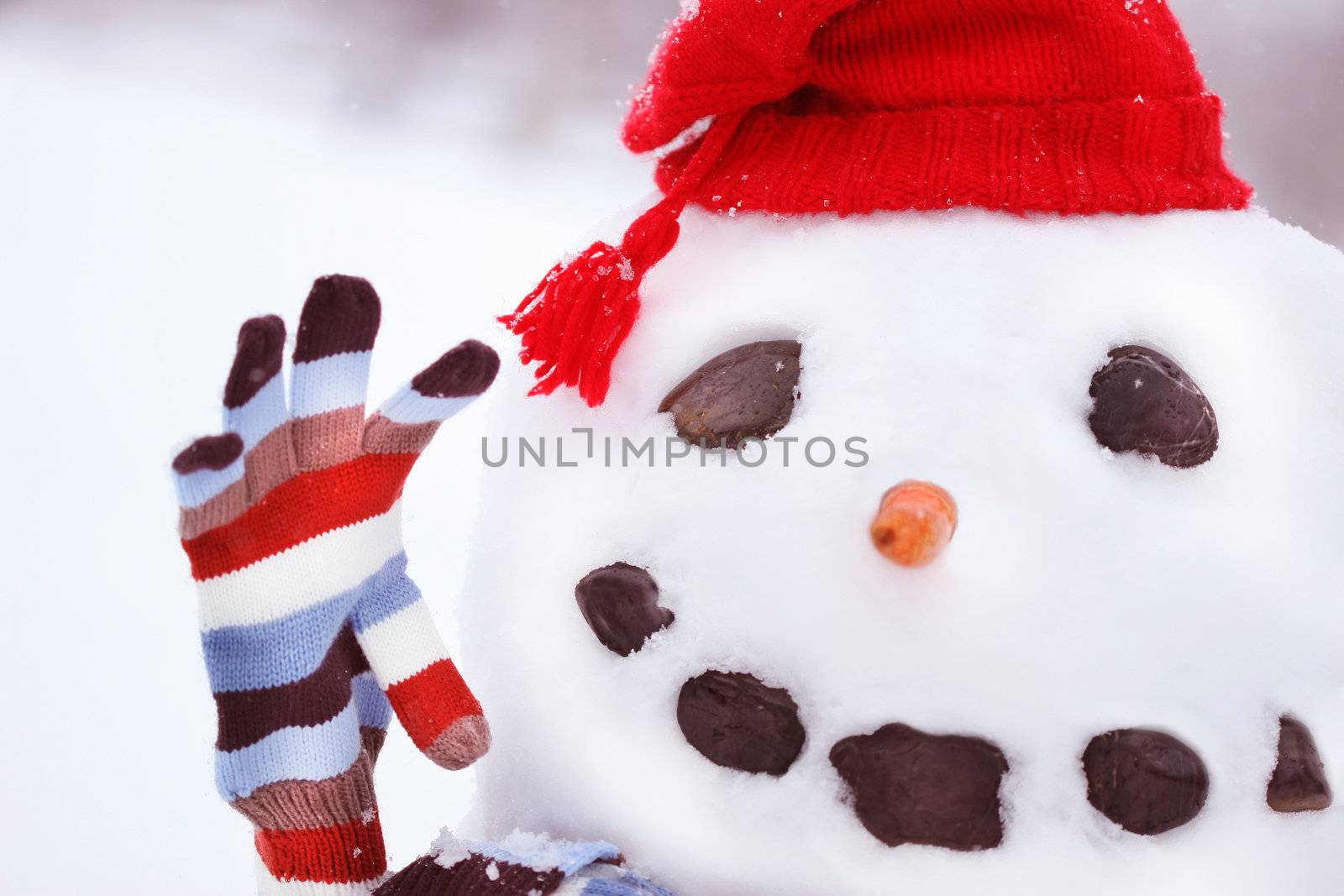 Snowman  in snow with big smile waving