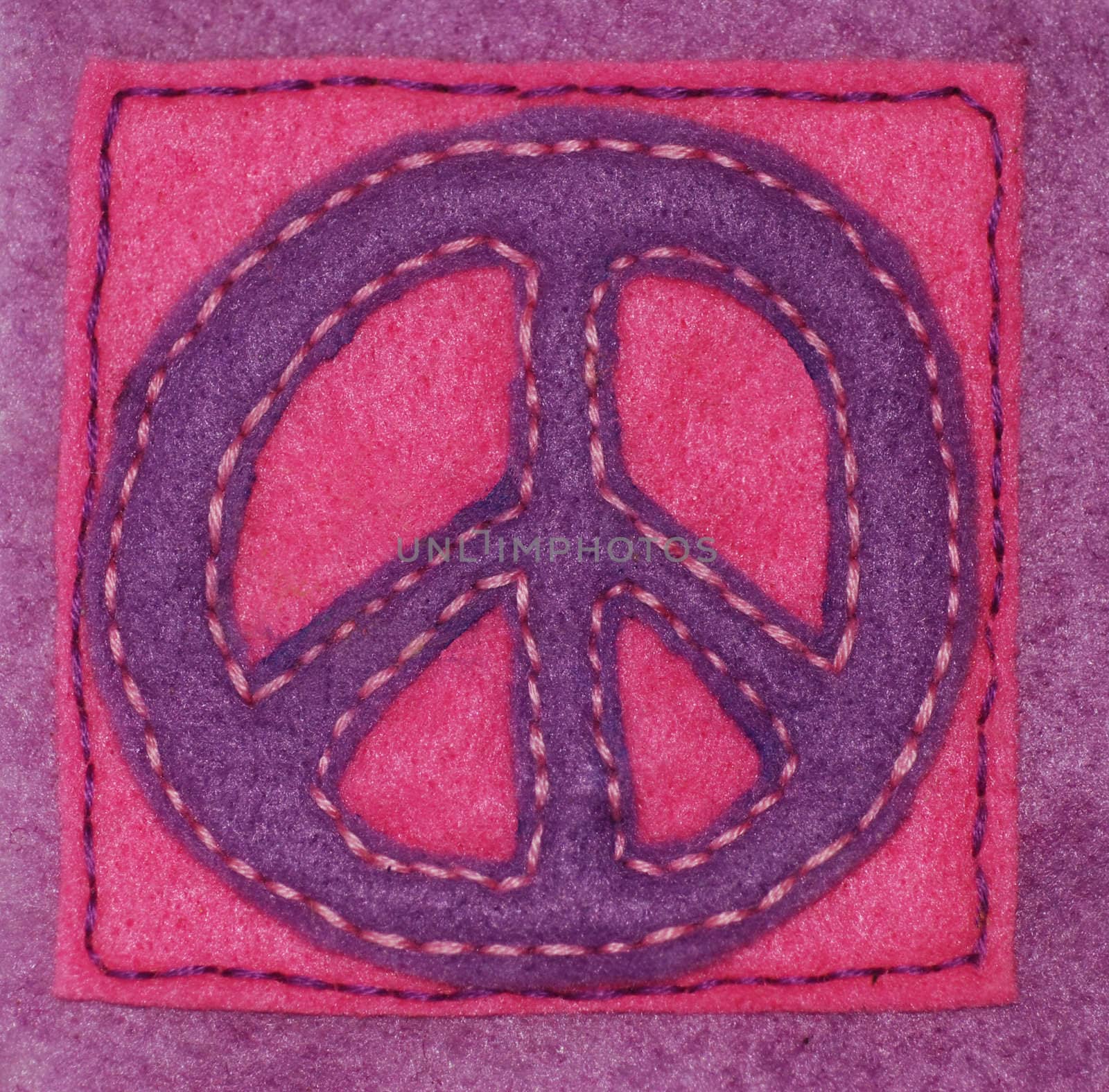 An anti-war symbol hand sewn on felt