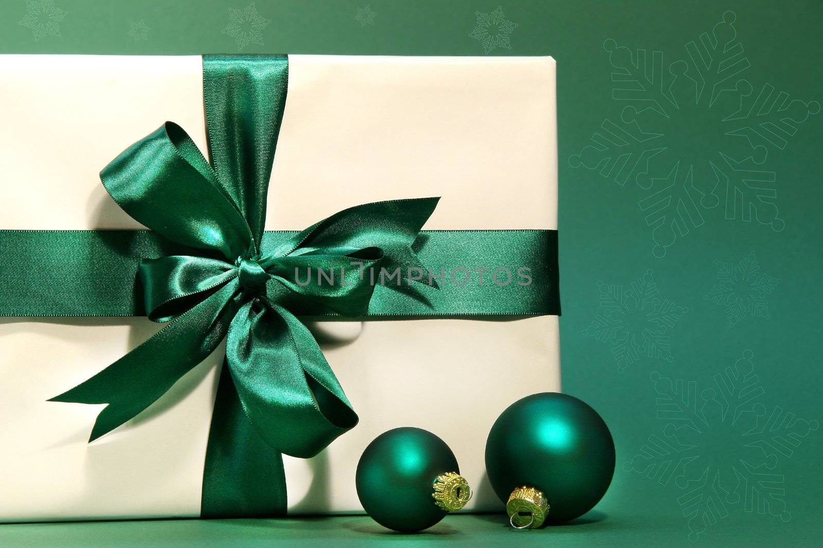 Gift with green bow against a green background