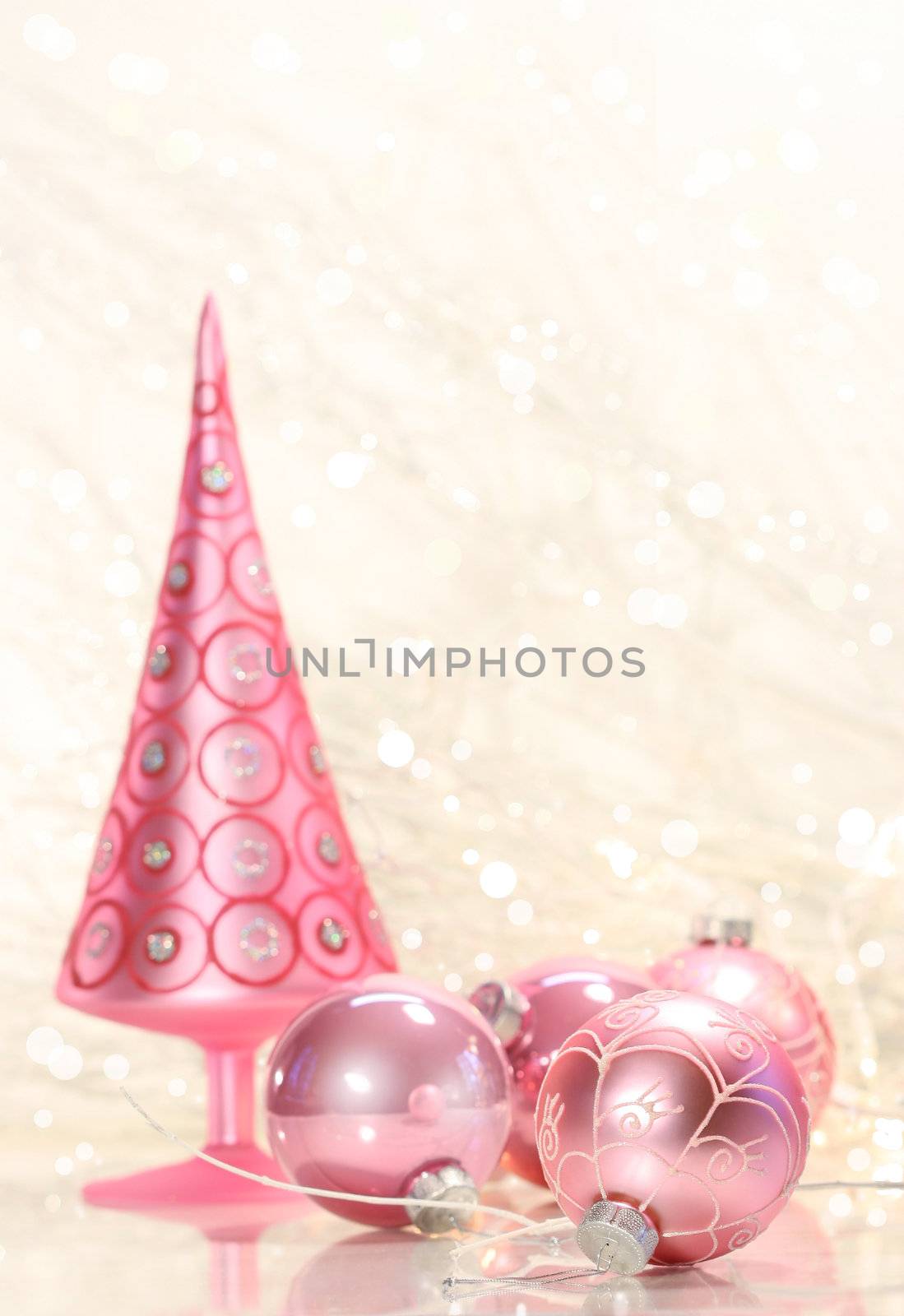 Pink holiday tree with glass balls and simmering background