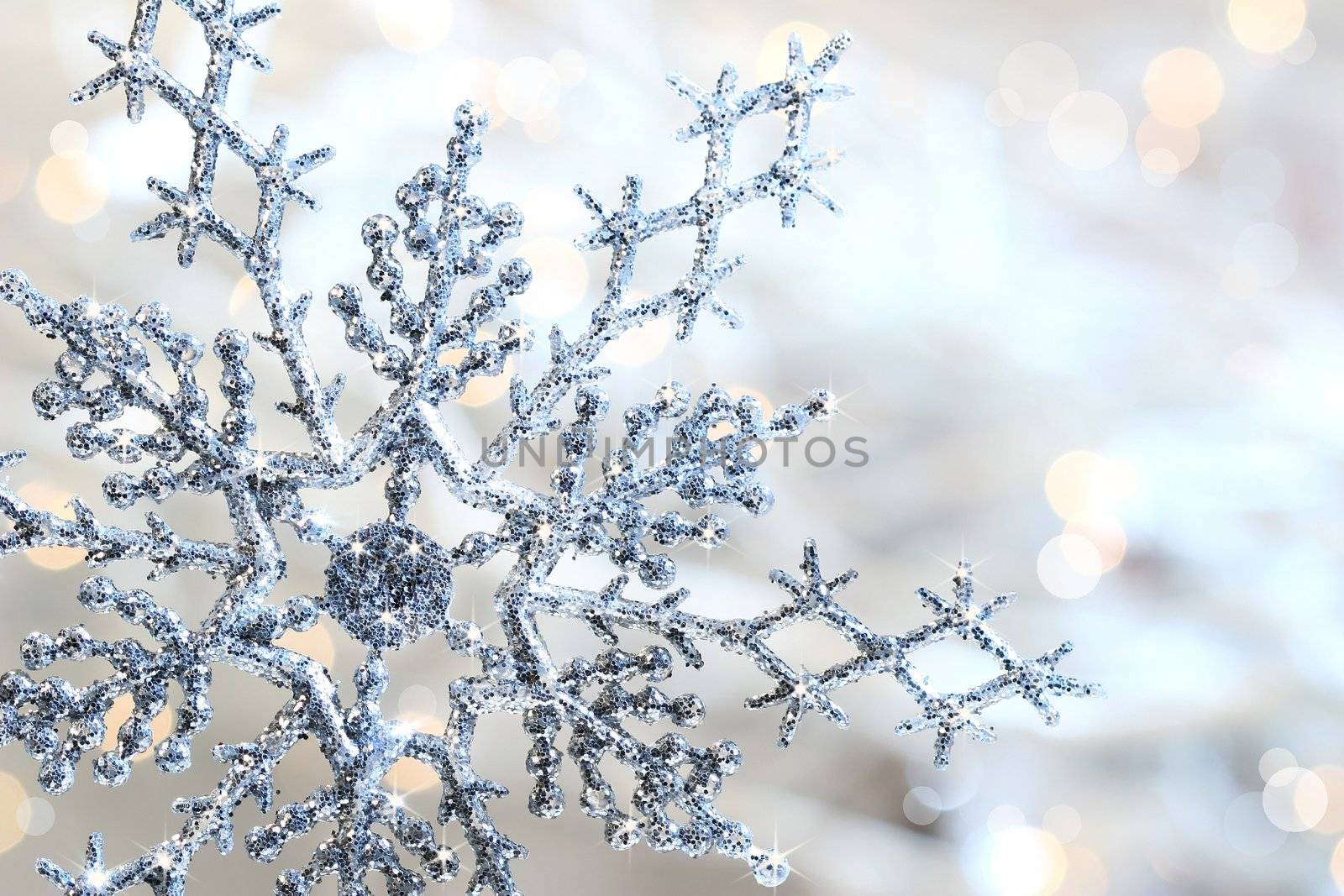 Silver blue snowflake against a shimmering background against a shimmering background
