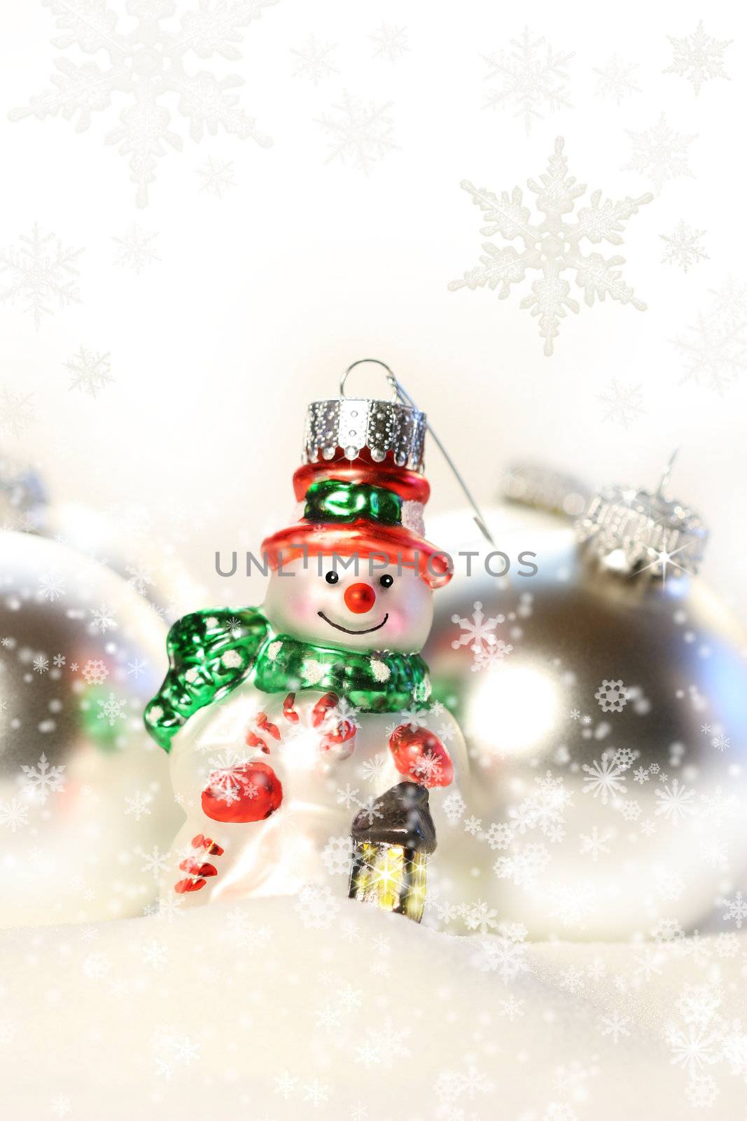 Little snowman ornament in the snow with white background