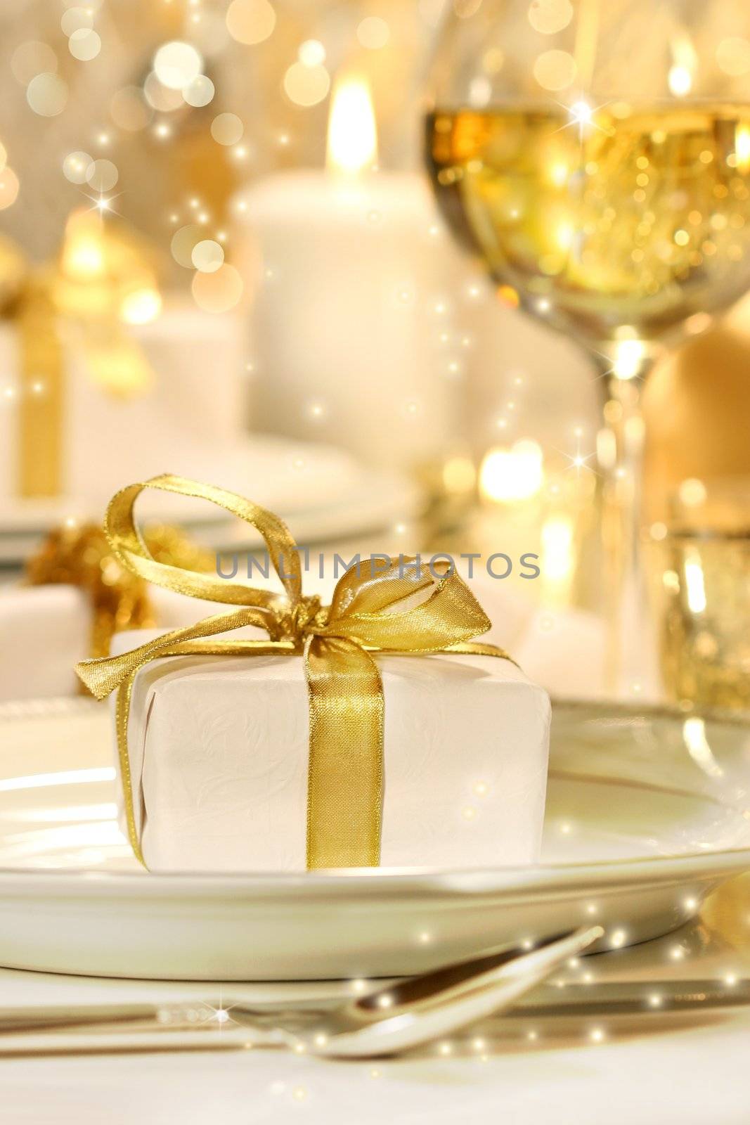 Little gold ribboned gift with gold background