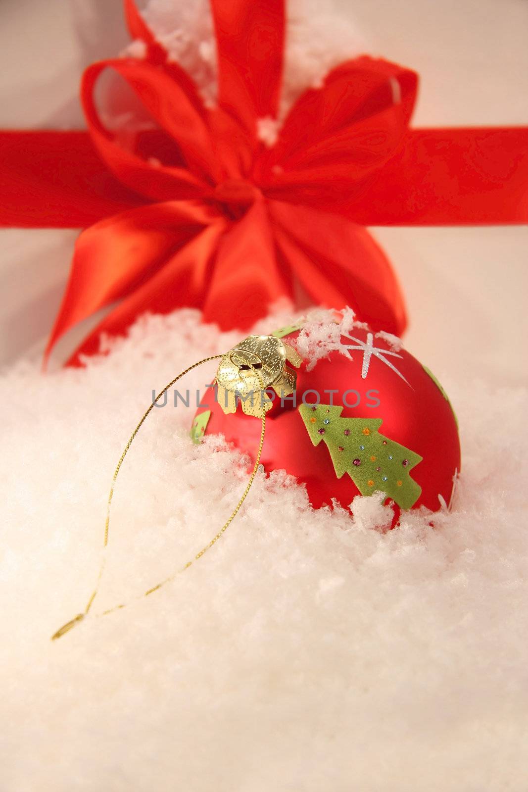 Red Christmas ball in the snow by Sandralise